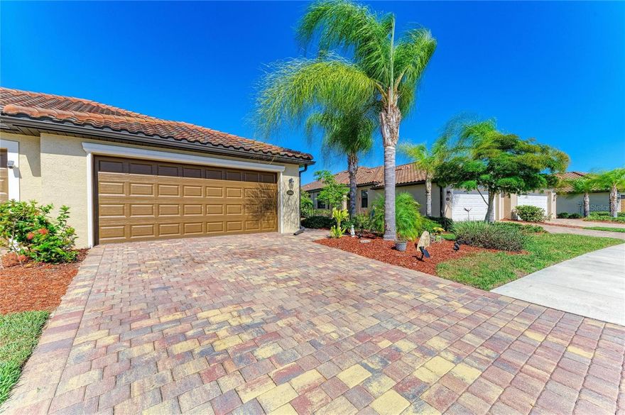 Welcome to this impeccably cared for model like villa tucked within the prestigious and highly desirable Gran Paradiso community in Venice. Surrounded by towering palm trees and vibrant tropical greenery, this refined home embodies the spirit of effortless Florida living while delivering an exceptional combination of elegance, comfort, and accessibility. 
Thoughtfully designed for contemporary living, the villa boasts a bright and airy open concept layout bathed in natural light through expansive windows and sliding glass doors. The generous living and dining spaces connect effortlessly to a beautifully appointed kitchen showcasing granite countertops, premium appliances, ample cabinetry, and extensive counter space, perfectly suited for both casual daily living and hosting guests.
The villa features two well appointed bedrooms, the home includes a flexible office and den area that can readily transform into a third bedroom, additional guest space, or a quiet private study, providing adaptability for a wide range of lifestyles. 
The primary suite functions as a serene personal sanctuary, complete with dual closets, and a luxuriously finished ensuite bath boasting double vanities, a deep soaking tub, and a generously sized walk in shower. The guest bedroom is spaciously appointed and provides plenty of room for family and overnight visitors, while the second bathroom is elegantly designed with a refined vanity and a practical tub and shower combination.
The private screened lanai is a charming outdoor haven adorned with crafted brick pavers, ideal for soaking in the peaceful tropical atmosphere surrounding you.
Gran Paradiso residents benefit from an outstanding array of resort inspired amenities, including a stunning community pool, a fully equipped fitness center, and meticulously landscaped walking paths winding throughout the neighborhood. Whether you lean toward an active routine or quiet relaxation, this thriving gated community has something to offer every resident.
Perfectly positioned near the flourishing Wellen Park corridor, homeowners enjoy easy access to a diverse selection of dining, specialty shops, cozy cafés, entertainment options, and lively community gatherings. CoolToday Park, is the official spring training venue of the Atlanta Braves, provides year round events ranging from sporting activities and concerts to neighborhood festivities that contribute to the area's energetic character. A brief drive leads you to Historic Downtown Venice, where you'll discover eclectic boutiques, alfresco dining, weekly farmers markets, art showcases, live performances, and the warm charm of a classic coastal community.
Venice is celebrated for its breathtaking Gulf Coast beaches, picturesque nature trails, and abundant outdoor pursuits including boating, kayaking, fishing, and golf, all set against the backdrop of spectacular sunsets. The region is recognized for its close knit community spirit, outstanding medical facilities, highly regarded schools, and straightforward access to Interstate 75, putting Sarasota, Fort Myers, Tampa, and the broader region well within reach.
Whether your vision is a seasonal getaway, or a permanent place to call home, this villa represents a remarkable chance to immerse yourself in the resort style living Gran Paradiso offers and discover the very finest that Venice, Florida has to give.