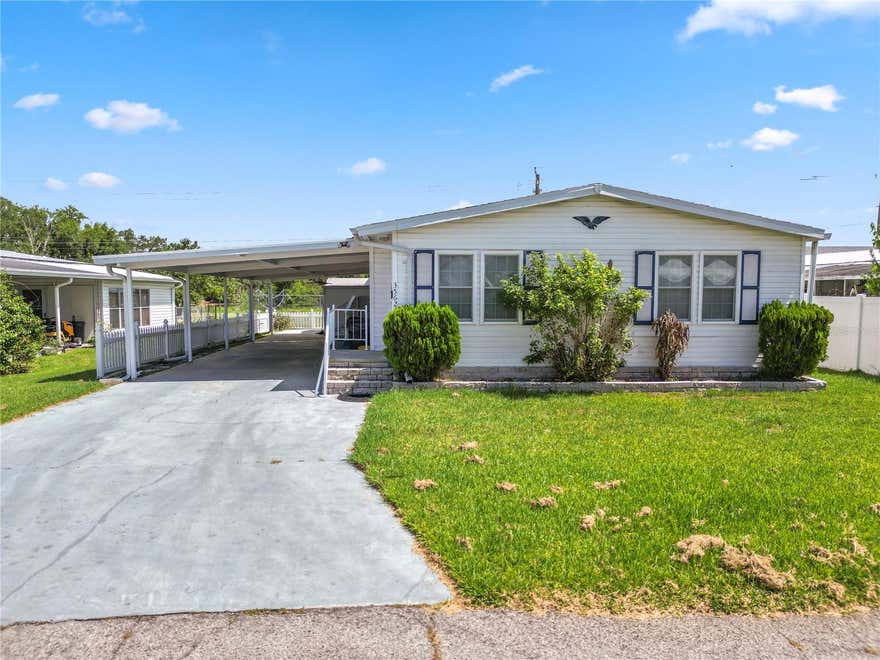 Welcome home to this well maintained 3 bedroom, 2 bath mobile home located in a peaceful and quiet community. Inside, you'll find tile flooring in the kitchen and bathrooms for easy maintenance, while the living area and bedrooms feature comfortable carpeting. Recent upgrades include newer windows and rain gutters, adding both value and functionality.

The spacious Florida room provides the perfect place to relax, entertain, or enjoy your morning coffee while taking in beautiful lake views. A Toshiba portable air conditioning unit helps keep the Florida room comfortable year round. Outside, you'll appreciate the vinyl picket fence in the backyard, creating an inviting space for pets, gardening, or outdoor enjoyment. The covered carport features a built in handicap accessible ramp, offering added convenience and accessibility.

Whether you're looking for a primary residence, seasonal retreat, or investment opportunity, this home offers comfort, accessibility, and scenic waterfront living in a tranquil setting. Schedule your private showing today!