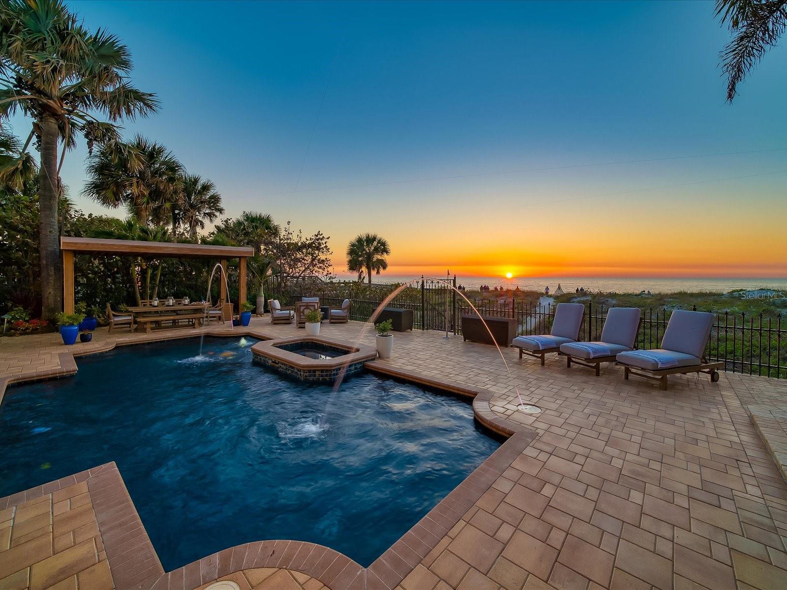 Back on the market and better than ever! This magnificent beachfront estate is a rare chance to own a slice of Florida paradise with investment opportunities! The property includes a 5507 square foot main house right on the white sand beaches of the Gulf of Mexico and a separate 3 bedroom 2 1/2 bathroom guest house (1407 square feet) directly behind it. Re-built in 2009 and renovated again in 2022 to the highest construction standards, including poured concrete with steel reinforcement, impact windows and doors, whole house generator, custom iron railing, hardwood hickory flooring, and so much more! The superior construction has stood the test of time and is apparent from the moment you enter. Your eyes will immediately be drawn to the architectural design and sweeping beach views that will take your breath away. Classic elegance meets modern sophistication that features soaring 25 foot ceilings in the great room and 14 foot ceilings throughout the rest of the home, dramatic lofts with mesmerizing views of the gulf beaches, stunning custom staircase, and resplendent living room with impressive built-ins. Filled with high-end appointments and stunning attention to detail, the open floor plan includes a gorgeous chefs’ kitchen with a large island, breakfast bar, custom wood cabinets and Sub-Zero and Thermador appliances. The formal dining room is perfect for entertaining and features a wine cooler and a wet bar. Upstairs you will find the stunning and luxurious master suite, complete with dressing areas, huge walk-in closet and a separate steam shower. The remaining bedrooms and baths, one of which is on the main level, are beautifully appointed with cozy sitting areas and private porches to enjoy the breathtaking sunsets. Additional features of this home include a workout/bonus room, elevator, new roof, A/C, new interior and exterior paint, new electric panels, light fixtures, and so much more. Ample parking, with a 3-car garage and 7 additional parking spots, is indeed a great feature and is highly valued on any beach property whether you decide to use this for yourself or as 2 short term rental properties. Ask about rental history and rates for both the cottage and the main house.