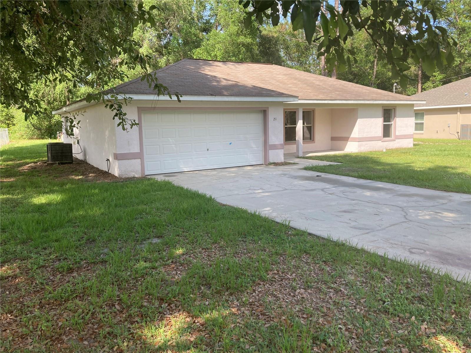 Welcome to this charming 3-bedroom, 2-bathroom home located in Silver Springs Shores, SE Ocala, FL. This home boasts a range of amenities designed for comfortable living. The kitchen is equipped with a dishwasher, refrigerator, and range, making meal preparation a breeze. The home also features washer/dryer hookups for your convenience. The master bedroom is a true retreat with a walk-in closet and an ensuite bathroom. The home is adorned with ceramic tile flooring throughout, adding a touch of elegance and ease of maintenance. The open back patio and large backyard give ample space for outdoor activities or simply enjoying the Florida sunshine. The covered front patio adds a welcoming touch to the home's exterior. The home also includes a 2-car attached garage, providing plenty of storage space. The property is serviced by a well and septic system. With large closets in every room, storage will never be an issue. This home truly offers a blend of comfort and convenience.