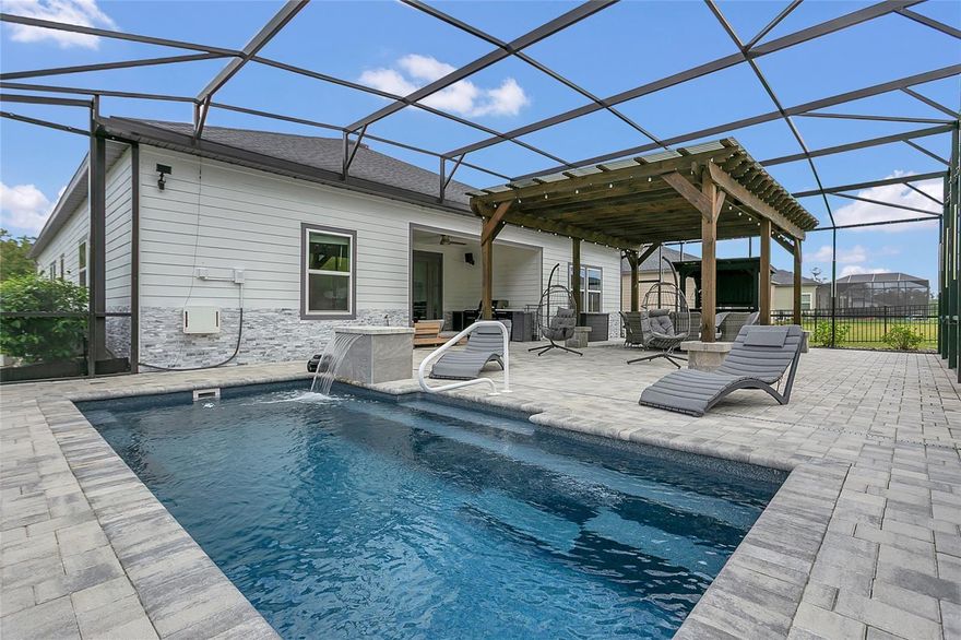 Welcome to Bellechase, one of Ocala’s most exclusive and sought-after guard-gated communities, known for its winding streets, mature oaks, and peaceful atmosphere. This stunning corner-lot, 4-bedroom, 3-bath home with a bonus flex room is the perfect blend of elegance, comfort, and Florida living at its finest. Every inch of this property has been fully upgraded, offering a home that feels brand new from the moment you pull into the full paver driveway, framed by lush professional landscaping and custom stonework that gives the home incredible curb appeal.
Inside and you’re greeted by an open floor plan designed for today’s lifestyle. The spacious living area flows seamlessly into the heart of the home — a modern, fully upgraded kitchen with new stainless-steel appliances, custom cabinetry, and upgraded lighting throughout that ties everything together. The flex room, just off the main space, is perfect for a home office, formal dining area, or playroom, giving you the versatility to make the space fit your family’s needs.
The primary suite is a true retreat, featuring a spa-inspired bathroom with double vanities, a soaking tub, and a large walk-in shower. A second ensuite bedroom provides the perfect setup for guests or in-laws. Throughout the home, you’ll find modern lighting upgrades inside and outside, beautiful flooring, and attention to detail that brings a clean, fresh look to every room.
Outside you'll see what makes this home truly one-of-a-kind. The expansive outdoor living area is designed for year-round enjoyment—whether relaxing with family or entertaining guests. Enjoy your brand-new saltwater pool, surrounded by a fully screened patio and an oversized pergola-covered area perfect for lounging in the shade. Fire up the outdoor kitchen for weekend barbecues, gather around the custom fire pit on cool evenings, and take in the resort-style landscaping that surrounds the entire property—a $50,000+ investment in landscaping alone!
Additional features include an EV charger hookup in the garage, modern new exterior lighting, and the peace of mind that comes with living in one of Ocala’s most desirable and secure neighborhoods. Bellechase offers wide streets, beautiful walking paths, and a true sense of community, all just minutes from top-rated schools, fine dining, shopping, and some of Central Florida’s most beautiful natural areas.
This is more than just a home — from the high-end finishes to the amazing outdoor spaces, every detail has been designed for comfort, style, and lasting enjoyment. Don’t miss your chance to own this incredible property in Bellechase — homes like this do not come along often!