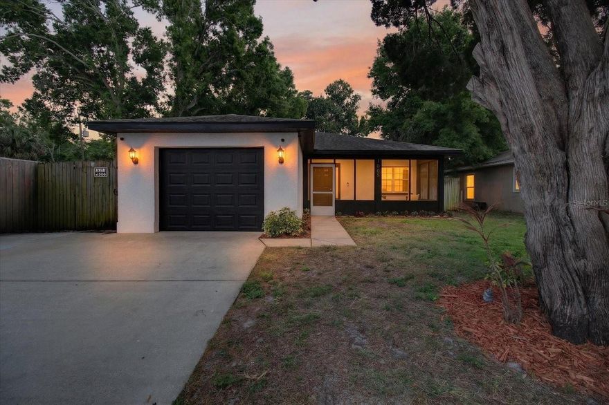 This beautifully updated block home tucked into one of Pinellas County’s most connected locations. From the moment you arrive, the fresh exterior, oversized driveway, and screened front porch set the tone for a home that feels both inviting and highly functional. Step inside to an open-concept living and dining space that feels anything but cookie-cutter, with LVP flooring throughout, a bold accent wall, stylish ceiling fans, and a designer lantern-lit entryway that leads you right into the heart of the home.

At the center of it all is the kitchen — a true showpiece with a large stone-topped island, bar seating, warm pendant lighting, stainless steel appliances, a sliding barn door, and modern farmhouse-style cabinetry. Whether you’re hosting friends, meal prepping for the week, or keeping an eye on the action while you cook, this space is designed to work the way you live.

The bedrooms encourage generous natural light, ceiling fans, and comfortable layouts, while the updated bathrooms feature modern vanities and sleek fixtures throughout. A dedicated office/bonus room with its own closet adds valuable flexibility for remote work, a creative studio, or even a fifth bedroom if needed.

Step outside and you’ll see where this home truly shines. A fully screened rear porch with a mounted TV opens to a spacious deck, concrete patio with a fire pit area, storage shed, and a fully fenced backyard lined with mature palms and tropical landscaping. This is an outdoor space you’ll actually use — perfect for entertaining, relaxing, or enjoying Florida evenings in your own private retreat.

The 2-car garage adds even more versatility with room for vehicles, storage, or a workshop, and the home is EV-ready with an electric vehicle charging setup already in place. Location is the finishing touch that makes this home such a rare find. You’re just one block from the Pinellas Trail, with easy bike access to Dunedin, Clearwater Beach, and St. Petersburg, while Missouri Avenue is steps away with everyday conveniences like Walmart, Aldi, and LA Fitness nearby. Belleair’s waterfront dining and golf courses are minutes away, and you’re just a short drive from the Gulf.

High and dry, with no flood zone and no evacuation zone, this is the kind of home that’s hard to find and even harder to leave.