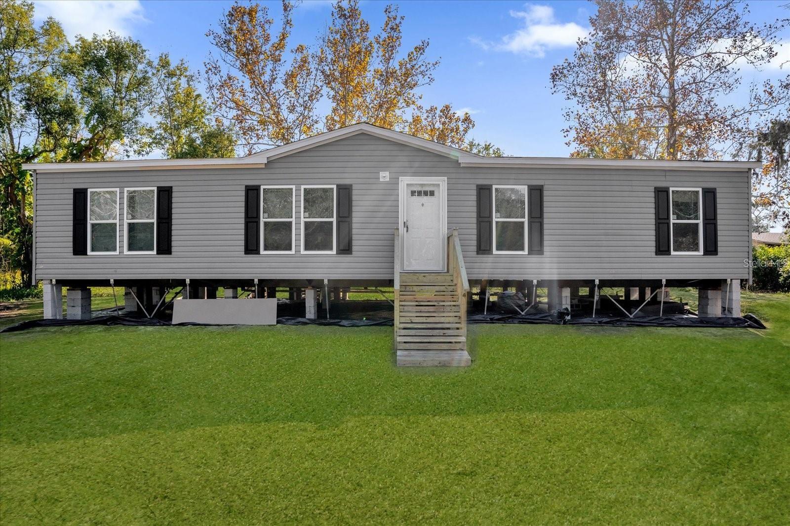 One or more photo(s) has been virtually staged. Under Construction. Welcome to this brand-new manufactured home at 2738 10th St Orlando, FL. Offering 1,456 square feet of thoughtfully designed living space, this 4-bedroom, 2-bathroom home is ready to become your perfect family retreat. Step inside to discover an open-concept living area filled with natural light, creating a welcoming atmosphere for daily life and entertaining. The kitchen features contemporary finishes that blend style with functionality. All bedrooms provide comfortable spaces for rest and relaxation, while the two full bathrooms ensure convenience for the whole family. This home comes complete with new septic and well systems, giving you peace of mind about essential infrastructure. The property's layout offers plenty of room for outdoor activities and future improvements. Whether you're dreaming of adding a pool, building additional structures, or creating your own backyard paradise, the possibilities are endless on 1.52 acres of cleared land. Located in a convenient area, you'll find easy access to daily necessities and entertainment options. Shopping centers, restaurants, and major roadways are within reach. Theme park enthusiasts will appreciate the proximity to Orlando's world-famous attractions, while frequent travelers will benefit from the nearby airport access. Don't miss this opportunity to own a brand-new home that combines modern comfort with the flexibility to create your ideal living space.