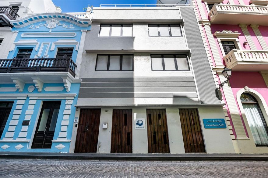 Nestled in the heart of historic Old San Juan, this exceptional three-story commercial property with a rooftop offers a unique blend of hospitality, coworking, and entertainment spaces. Originally built in the 1930s and thoughtfully remodeled in 2020-2021, it seamlessly blends historic charm with modern convenience. Just steps away from boutique shops, top-rated restaurants, and iconic landmarks like Castillo San Cristóbal and El Morro, this property enjoys high foot traffic and a prime location in Puerto Rico’s charming capital.  
The ground floor features a welcoming restaurant and coffee shop at the front, perfect for capturing the daily buzz of the area, while the back houses a hidden speakeasy-style bar, offering an intimate nightlife experience. The second and third floors are dedicated to modern coworking and office spaces, designed for flexible rentals similar to Spece and Piloto, with private offices, meeting rooms, and shared workspaces catering to entrepreneurs and professionals.  
Topping it all off, the rooftop boasts a stylish open-air bar with breathtaking views of Old San Juan, making it an ideal spot for social gatherings and private events. Whether as an investment or a business opportunity, this dynamic property seamlessly combines history, functionality, and income-generating potential in one of the most sought-after locations on the island.