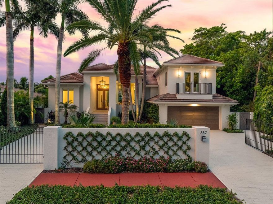 ST ARMANDS WATERFRONT RESIDENCE. This stunning canal-front home was distinctively reimagined and completely renovated in 2021 by Murray Homes with interior selections by Elizabeth Krueger Designs. A luxurious modern coastal retreat unlike any other with 3,268 sq ft of interior living space, this impressive open-concept design offers 4 bedrooms, and 5 full bathrooms. The unparalleled location boasts the best of Florida living with 82-feet of water frontage that includes a new seawall, dock and combination platform lift for Wave Runners /paddleboards. This private, gated residence is conveniently positioned just two blocks from St. Armands Circle, with its award-winning restaurants and shops, within walking distance of Lido Beach, and just a short drive from downtown Sarasota, or beachfront resorts and golf. Meticulous attention to detail is evident as soon as you approach the residence with architectural elements and designer finishes that showcase the unrivaled craftsmanship and exceptional design. Sophisticated accents throughout such as the custom entry doors, beautiful Aspen Spring Catalina Oak wood flooring, and voluminous ceilings with architectural accents in the dining room, family room, and primary suite, make this home the epitome of luxury and style. The gourmet kitchen is a showpiece at the heart of the open living space, with striking Calacatta Viola Monet marble countertops and backsplash, spacious island with seating, custom Windy Chien lighting installation, and maple cabinetry. The well planned space is fully equipped with top-of-the-line appliances including a 36” professional Wolf induction range, Thermador microwave and dishwasher, and Sub-Zero refrigerator. A custom open walk-in pantry with floating shelves and maple cabinetry in a coastal finish, adds both convenience and style. The private primary suite is a true luxury retreat, beautifully appointed with designer finishes such as a vaulted tongue-and-groove wood ceiling, sliders that open wide to the terrace, a generous custom walk-in closet, and an exquisite en suite bathroom. A second spacious suite rivals the primary bedroom to delight your guests with sliders that open to the water, a custom walk-in closet, and a fabulous en suite bathroom with dual vanities, and seamless glass walk-in shower. The 3rd bedroom is adjacent to the main bathroom, and off the kitchen is the stylish laundry room with quartz counters, an apron sink, and built-in cabinetry. The upstairs brings you to the lofty bunkroom, the 4th bedroom, with French doors to the private balcony, and en suite bathroom. The zoned A/C systems are an added convenience, including a mini-split system in the oversized 2-car garage that greets you in comfort as soon as you pull in from the private and gated paver driveway. Magnificently spacious and open, the home’s interior design seamlessly extends outdoors to the waterfront through generous windows and expansive sliding doors that open from the living areas to covered terraces, manicured hardscapes, and the relaxing canal-front pool, spa, and dock. The Southwestern rear exposure and tropical landscape make an ideal backdrop for picturesque sunsets over the intracoastal waterway, and the versatile indoor/outdoor living space is ideal for memorable gatherings. Live the island dream from sought-after St Armands Key, in this luxuriously  renovated waterfront coastal sanctuary.