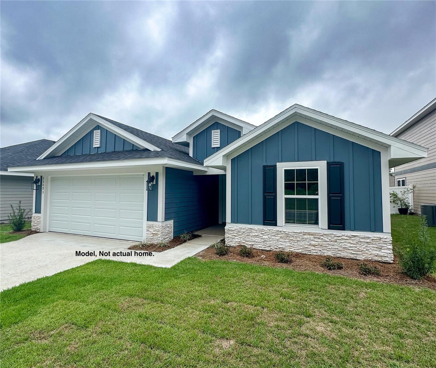 Under Construction. Builder incentives of 15k to cover closing costs, upgrades or rate by down and only a $1,000 deposit secures the home. This new construction home by Adams Homes offers approximately 1,635 square feet with 4 bedrooms and 2 bathrooms. The open floor plan includes a kitchen island with a combined living and dining area. Interior details feature solid wood, soft-close cabinets and drawers, brushed nickel fixtures, LED lighting throughout, and an in-wall pest control system.
The home provides a 2-car garage with stacked stone accents on the front elevation, along with covered rear porch. Located on a 1/4-acre lot in the Rolling Hills community of Bell, FL, this property offers a rural setting with country living only 8 minutes from the Suwannee River. A 10-year structural warranty is included.