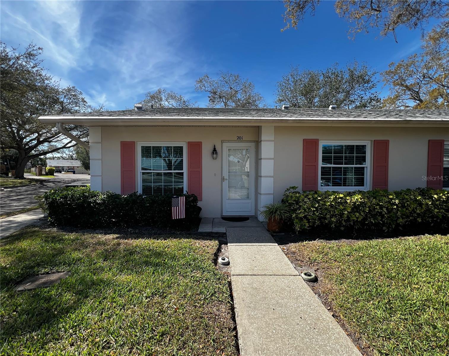 Welcome to Nelson Place- a highly sought after 55+ community in Clearwater that features ground floor villa style condos (with no upstairs neighbors), beautiful mature oak trees and landscaping, and is walkable to a Publix shopping center with a variety of stores. Enjoy the peace of mind being in a non-flood zone (Zone X)! This ground floor end unit has been meticulously maintained, and is highlighted by a wall of windows that bring in bright natural light throughout the entire condo. This villa has updated windows, a newer water heater, and boasts an open floor plan with two bedrooms and two bathrooms, a sunny Florida room, plus a back patio for enjoying the Florida weather or planting your favorite plants. The kitchen has an opening that is perfect for bar stool seating, plus space for a breakfast table. The living and dining room combo feature laminate flooring, a vaulted ceiling, and leads into the sunny Florida room at the rear of the condo. You also have a paver patio with space for seating, a grill, and your favorite plants. Both bedrooms have a window for natural light, and spacious walk in closets. The guest bathroom connects to the guest bedroom through a hallway that can be shut off from the main living space for a more private/ suite like feel, and the primary bedroom has a private attached bathroom with a walk-in shower. Enjoy the little things, like a spacious inside laundry closet, covered parking just steps from your door, a heated and spacious pool with plenty of lounge chairs to enjoy the sunshine, and a smaller community with just 31 condos. Publix is a short walk around the corner plus shops, restaurants, nail salon, gym, etc. Eagle Lake Park is a short drive from the community, as well as Clearwater Beach and both Tampa and St Pete/ Clearwater airports. This central Pinellas location is the perfect home base for you as you enjoy the best of Tampa Bay with our award winning beaches, shopping, restaurants, and golf. Don't miss out on this wonderful condo! Please note: no dogs allowed, only one cat or bird.