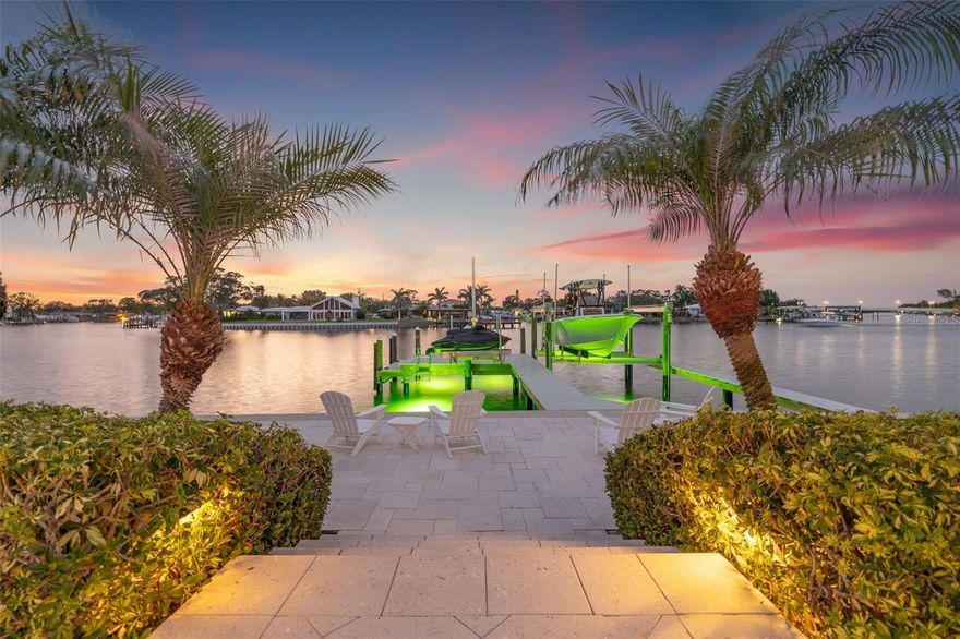 Coastal Waterfront Luxury on Snell Isle in the peaceful enclave of Eden Isle. (THIS HOME DID NOT EXPERIENCE ANY DAMAGE OR WATER INTRUSION FROM RECENT HURRICANES) Experience effortless coastal luxury living in this beautifully updated waterfront pool home with new seawall, dock and boat lifts. Perfectly positioned on Smacks Bayou with instant access to Tampa Bay, this exceptional residence offers a well-designed living space, featuring two private primary suites, a split floor plan, and seamless indoor-outdoor flow that defines the relaxed sophistication of St. Petersburg’s coastal lifestyle. From the moment you enter, you’ll appreciate the home’s versatile layout, which includes both formal and casual living and dining areas—perfect for hosting guests or enjoying quiet evenings at home. At the heart of the home, the thoughtfully designed kitchen blends functionality with elevated style. It features a large center island, custom wood cabinetry, stainless steel appliances, a wine refrigerator, and a convenient pass-through window to the covered lanai—ideal for entertaining and everyday living. The main primary suite is a peaceful and private retreat, offering two generous walk-in closets and a newly updated en suite bathroom with dual sinks and a spa-like glass-enclosed shower. The second primary suite—ideal as a guest suite, home office, or den—features a charming bay window that perfectly frames stunning water views, an en suite bath that also serves as a convenient pool bath, and its own private space tucked away for comfort and flexibility. Step outside and embrace the ultimate St. Pete lifestyle from your own tropical oasis. Watch dolphins and manatees play in the bayou as you sip your morning coffee, or unwind in the evening with a cocktail and a vibrant sunset. The outdoor space is designed for year-round enjoyment, featuring a resort-style pool and spa, a fully equipped outdoor kitchen, and lush, private landscaping. A newer paver walkway connects the pool area to the dock, completed in 2022, which features a 16,000 lb boat lift and a 1,500 lb PWC lift—your personal launch point to Tampa Bay, the Gulf beaches, or a quick boat ride to downtown St. Pete or Tampa. Additional upgrades include impact-rated windows and doors throughout, a new seawall, a new paver driveway and front porch (2022), a four-zone AC system installed in June 2024 and all new PVC pipe installed. *** Best of all, this home has had no water intrusion during recent hurricanes ***  a valuable reassurance for waterfront living. Ideally located just minutes from everything that makes St. Pete one of Florida’s most desirable coastal cities, this home allows you to take your golf cart downtown for Michelin-starred dining, sidewalk cafés, boutique shopping, world-renowned museums, the St. Pete Pier, and miles of scenic waterfront parks. Everyday conveniences like Whole Foods, Trader Joe’s, Publix, and Fresh Market are all nearby along the vibrant 4th Street Corridor. Whether you’re searching for a full-time residence or a luxurious waterfront retreat, this exceptional home perfectly captures the essence of modern coastal living in the heart of St. Petersburg.