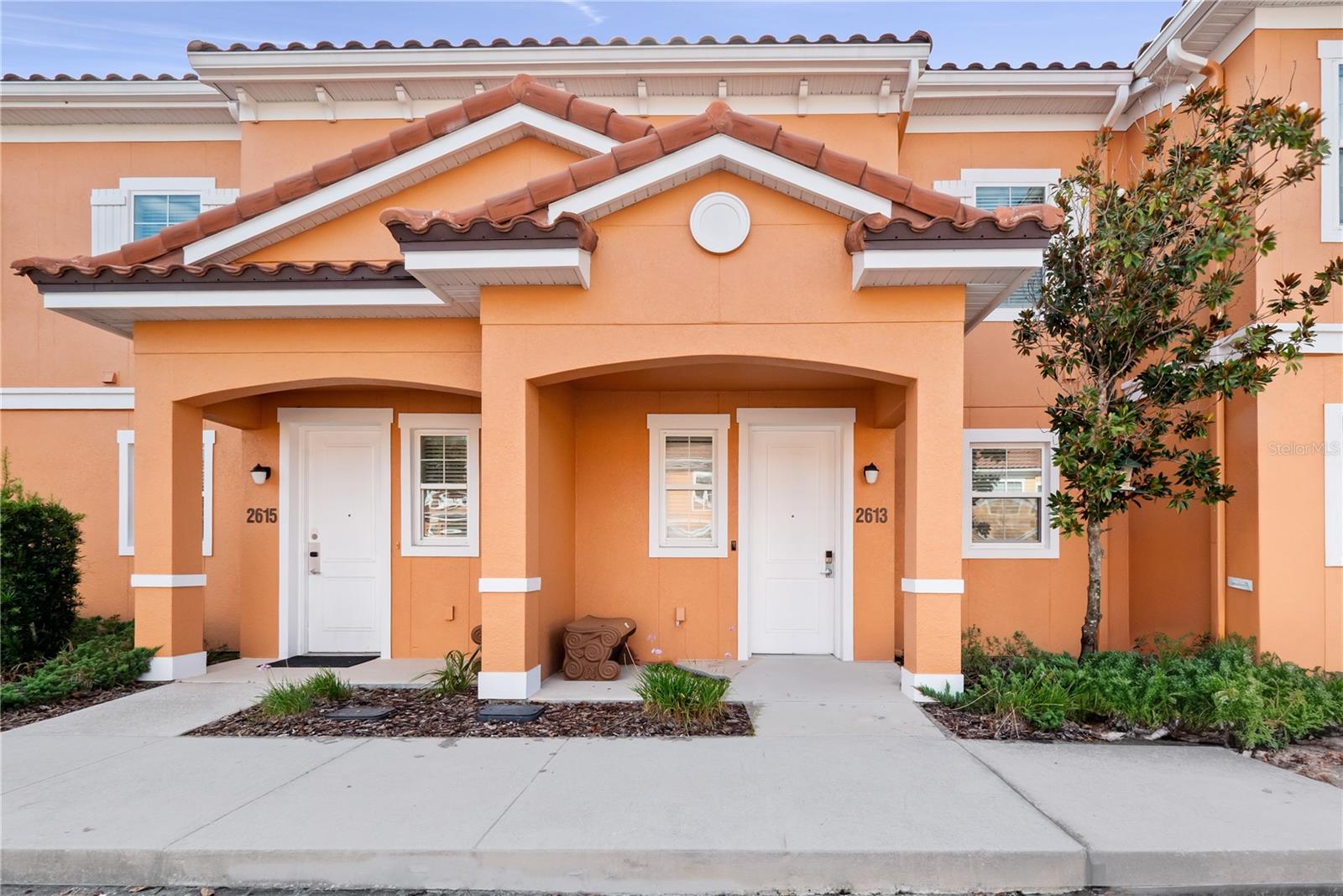 Beautiful Resort Community! This Tastefully decorated 2 Bedrooms 2.5 Bath Townhome in Regal Oaks at Old Town comes furnished and is perfect for a Vacation Rental or Primary Residence. Luxury Vinyl Plank was recently put on stairs and upstairs. Tile throughout the first floor. Stone countertops in kitchen and bathrooms. Location is key and close to all of the magic! You can ride your golf cart ?that is included with purchase? within the community and enjoy the wonderful Amenities that Regal Oaks offers or just take a short drive up the street to enjoy the fun at Old Town or go five miles to the gates of Walt Disney World! Enjoy all the restaurants and shopping that surrounds the area. Open floorplan on the first floor with your own personal outdoor oasis as you continue to the lanai. Completely screened and equipped with a free -standing hot tub for your enjoyment. Upstairs, the two bedrooms are on opposite sides of the home, adding to the privacy of each room. The primary suite features an ensuite bathroom, complete with dual sinks, and a shower/tub combo with glass enclosure. The second bedroom also has ensuite bathroom, with dual sinks and a glass-enclosed walk-in shower. Amenities at this resort include a large zero-entry pool; water slides; clubhouse situated on a picturesque pond; restaurant; fitness center; sundries shop; and tennis court. **Zoned for Short term and Long term Leasing **Golf Cart included
