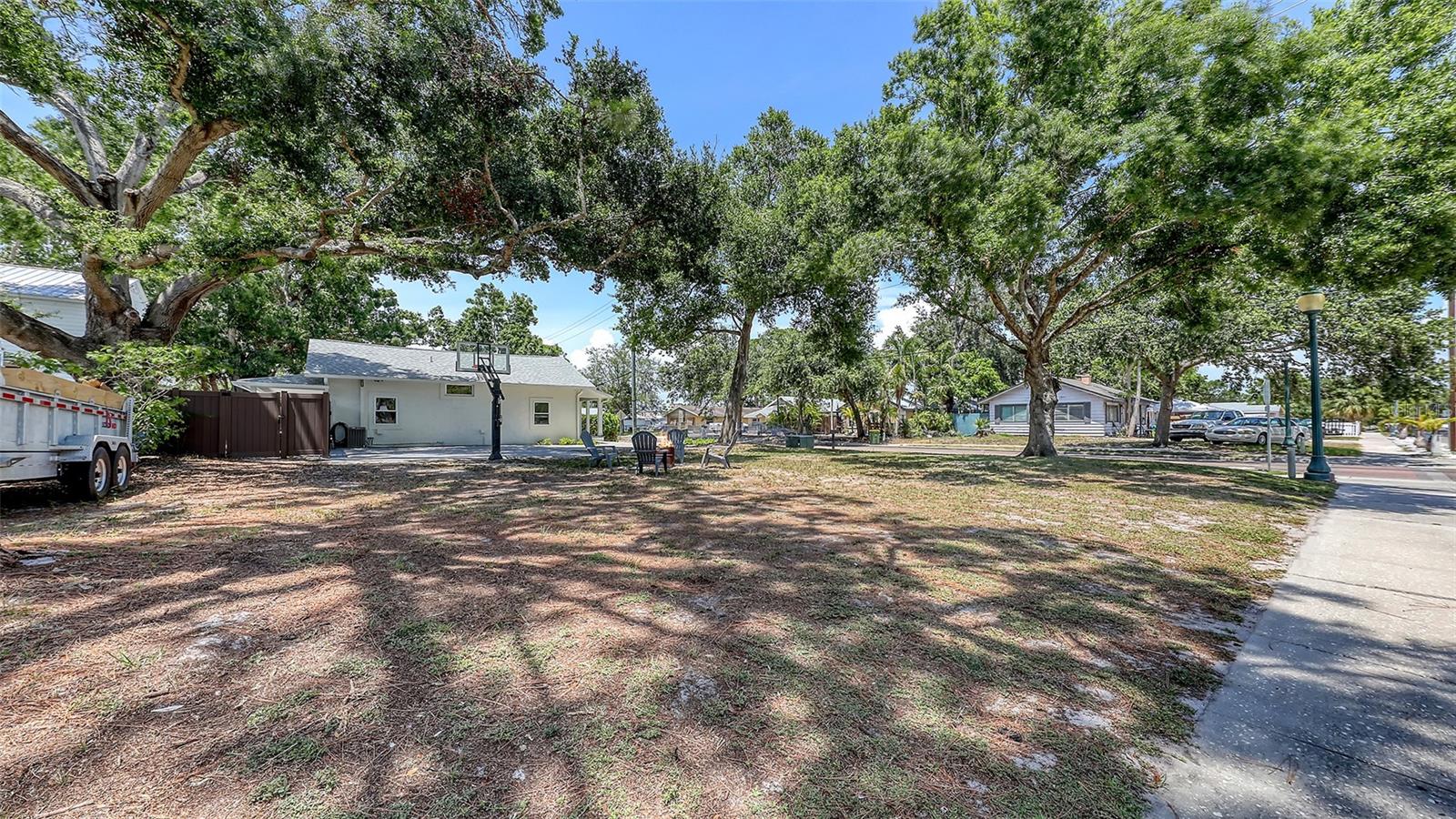 Prime Buildable Corner Lot in the Heart of Sarasota! Vacant parcels are hard to come by within the city limits, making this cleared and ready-to-build corner lot in Park East a true gem. Situated in one of the city's transforming neighborhoods, this property presents a rare opportunity to build a custom home or secure a smart, affordable investment in the direct path of downtown growth.
Positioned directly across from pleasant Shenandoah Park, the lot offers a scenic and quiet setting—with unbeatable proximity to restaurants, shopping, Farmer's market, Sarasota Bay and Gulf beaches. As Park East continues its upward momentum with revitalization and new development, the potential for appreciation and lifestyle value is undeniable. Home, garage and cottage next door at 815 N. East Ave. also for sale under MLS# A4654192.
Looking to expand your vision? The adjoining property is also available, featuring a main home, guest cottage, and a newer garage with a bonus studio above. Whether you're thinking multi-generational living, rental income, or land banking, the combination of both properties opens the door to a wide range of possibilities. See MLS# A4654192 for more information.
Whether you're a builder, investor, or future homeowner, don’t miss this rare opportunity to secure land in one of Sarasota’s up and coming areas.