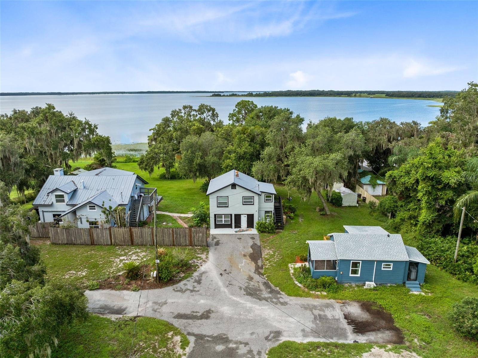 *INCOME PRODUCING PROPERTY ALERT* Charming Lakefront Opportunity on Alligator Lake – 1.36 Acres in Saint Cloud, FL. Welcome to a rare investment opportunity with 200 feet of pristine lake frontage on Alligator Lake, part of the renowned Alligator Chain of Lakes in Saint Cloud, Florida. This unique 1.36-acre property offers endless potential with three separate buildings, each full of character and built in 1945, providing an exceptional canvas for your vision. Nestled behind a private driveway, this peaceful retreat offers panoramic water views, ample space, and the perfect setting for a personal lakefront estate or income-generating opportunities. Whether you're dreaming of creating a lakeside oasis or capitalizing on the area's strong rental market, this property has the size, location, and charm to make it a standout. Don't miss this chance to own a slice of Old Florida charm with unbeatable lake access and boundless potential. *Buyer/Buyer's agent to verify room dimension, lot size and conforming use*