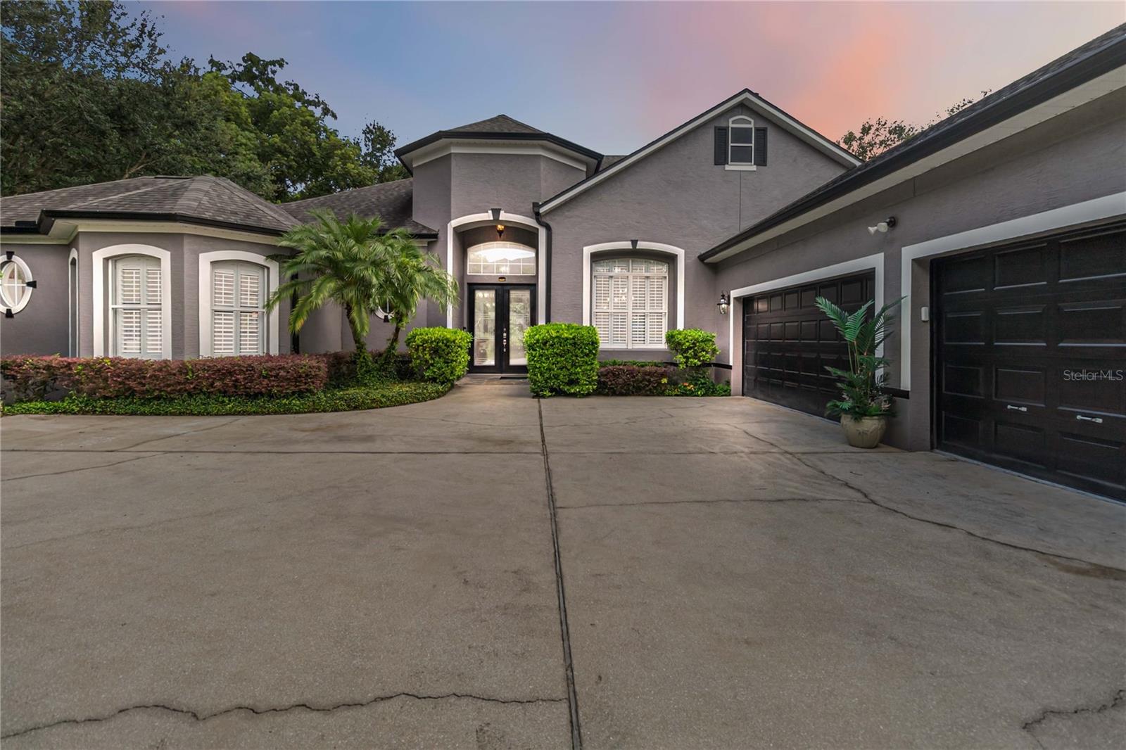 Welcome to Tucks Knoll in Winter Park! Nestled on over FOUR ACRES at the end of a private cul-de-sac, this exceptional 4-bedroom, 4-bathroom residence offers more than 3,300 square feet of luxurious living space and a lifestyle that feels like your own private retreat. Backing up to a lush CONSERVATION area with the peaceful flow of Howell Creek, the property is surrounded by mature trees, vibrant landscaping, and natural beauty at every turn.
The thoughtfully designed three-way split floor plan seamlessly balances entertaining with private comfort. Sun-filled formal living and dining rooms set a graceful tone, while the expansive great room with hardwood floors opens to the gourmet eat-in kitchen, complete with granite countertops, stainless steel appliances, a gas cooktop, tile backsplash, and a large pantry. A dedicated office with a bay window provides a quiet space to work, while the elegant primary suite impresses with cathedral ceilings, and a spa-inspired bath featuring dual vanities, a garden tub, and a spacious tile shower.
Grand sliding pocket doors off of the family room lead to an expansive wood deck, the perfect setting to enjoy serene mornings and peaceful evenings surrounded by nature. Upstairs is a dedicated state of the art THEATER ROOM with comfy leather seats and surround sound elevating family fun, There is even a FULL BATH. The main level additional bedrooms include a Jack-and-Jill setup and a private suite with a walk-in closet.
The backyard is a true showpiece—meticulously landscaped and thoughtfully planned. FRUIT TREES including ORANGE and FIG provide seasonal delights, while a beautifully maintained tiered garden bed produces sweet peppers, chives, and strawberries. Raised beds add even more bounty, offering eggplant and sweet potatoes. A large, level green space and a nicely CLEARED PATH to the creek invite both relaxation and exploration, creating an outdoor paradise that feels worlds away yet remains minutes from top-rated schools, shopping, and dining.
This is more than a home—it’s a one-of-a-kind sanctuary blending privacy, nature, and convenience. Don’t miss the opportunity to make it yours. Schedule your tour today!