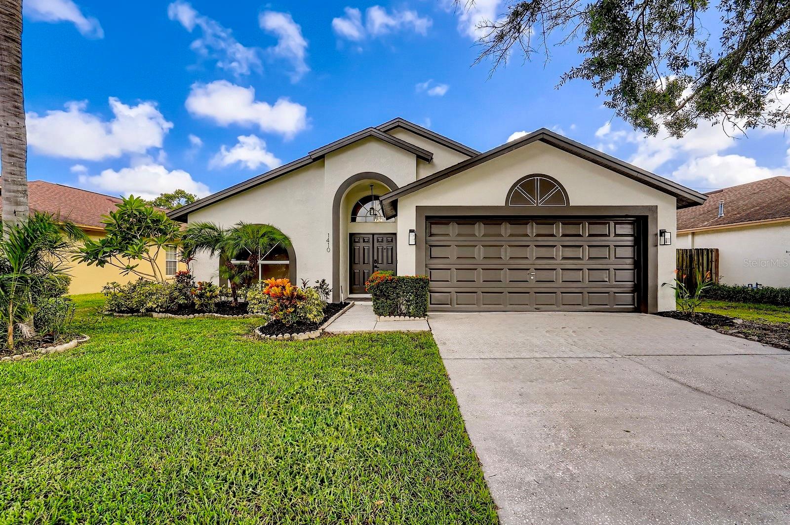 This move-in-ready home has been thoughtfully renovated from top to bottom. Freshly painted inside and out, it features new luxury vinyl plank flooring throughout and soaring vaulted ceilings that create a bright, open atmosphere. The brand-new kitchen boasts sleek quartz countertops, updated cabinetry, GE stainless steel appliances, a natural gas hookup, and modern fixtures—perfect for cooking and entertaining. Both bathrooms have been tastefully remodeled with elegant tilework, stylish vanities, and designer finishes. A tankless water heater provides energy-efficient comfort, and every detail has been updated for modern living. Enjoy Florida-style indoor-outdoor living in the oversized screened lanai, overlooking a fully fenced yard—ideal for pets, play, or peaceful relaxation. Providence Lakes offers the perfect blend of convenience and tranquility set amongst lush landscaping and tranquil lakes. Located just minutes from shopping, dining, and major freeways, this home combines style, comfort, and convenience in one beautifully updated package.