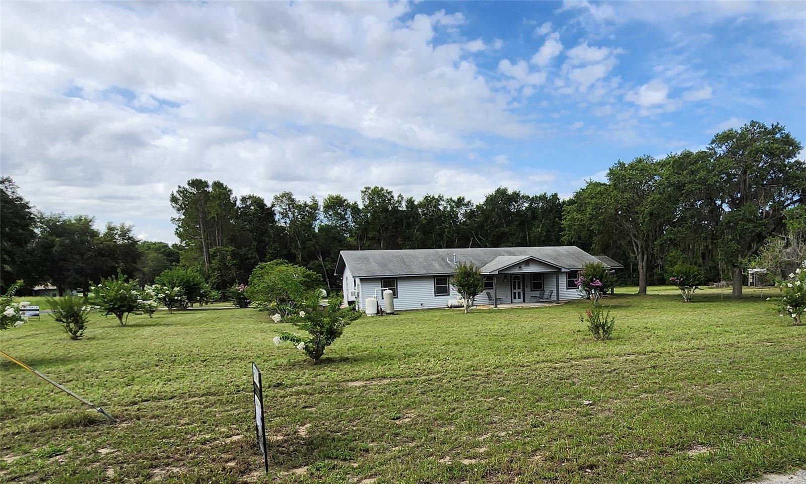 No HOA - Welcome to this beautifully updated 2-bedroom, 1.5-bath home, situated on a spacious .6-acre corner lot in the serene Town of Astatula. This home boasts numerous upgrades, including stunning new granite countertops, new dishwasher & disposal, newly remodeled bathrooms, new septic tank & drain field. Throughout the entire house, you'll find new flooring and fixtures, adding a fresh, modern feel to every room. The over-sized garage is a standout feature, offering ample space deep enough to accommodate a boat trailer, plus an additional storage room, and a private workshop/office perfect for your hobbies or projects. The home is also equipped with a large propane tank (owned not rented), powering the stove and hot water heater for efficient and cost effective living. Step outside and enjoy the tranquility of two covered porches, shaded by majestic oak trees, and a beautifully landscaped yard. Both the roof, and the A/C were replaced on 2014. For outdoor enthusiasts, the home is located less than 1 mile from the public pier and boat ramp to the Lake Harris Chain of Lakes. The listing agent is one of the owners. Buyer or their agent are to verify all measurements. See the Land Survey in the MLS Attachments. SELLER WILL PAY $3,000 TOWARDS INTEREST BUY DOWN or CLOSING COSTS.