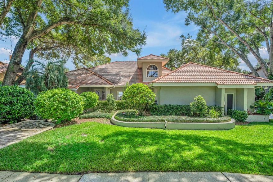 LAKEFRONT! WINTER PARK CHAIN OF LAKES!   Welcome to 944 Versailles Circle boasting expansive views of Lake Minnehaha from almost every room! This 2 story custom home with 110 feet of lake frontage offers an AMAZING outdoor screened oasis including sparkling pool with waterfall, brick paved living area, dining spot, sunning areas & built in bar overlooking back yard, boathouse & serene lake.  Step inside via impressive front courtyard & double doors and expect to be delighted with soaring ceilings & 3 way split plan.  The 22x18 first floor Primary Suite includes 19x8 bathroom with dual sinks, tub, separate shower, water closet & huge walk-in closet.  Oversized rooms include formal living, dining & family room with wood burning fireplace.  The light & bright kitchen with cozy breakfast nook, granite counters & stainless steel appliances overlooks tranquil outdoor living area. Bedroom #2 is located on first floor and upstairs you will find 2 LARGE guest suites with jack & jill bathroom, lake views & 2 walk-in storage closets.  Extras include: oversized 24x23 side entry garage, tile roof & quaint tree canopied neighborhood.  WELCOME HOME!