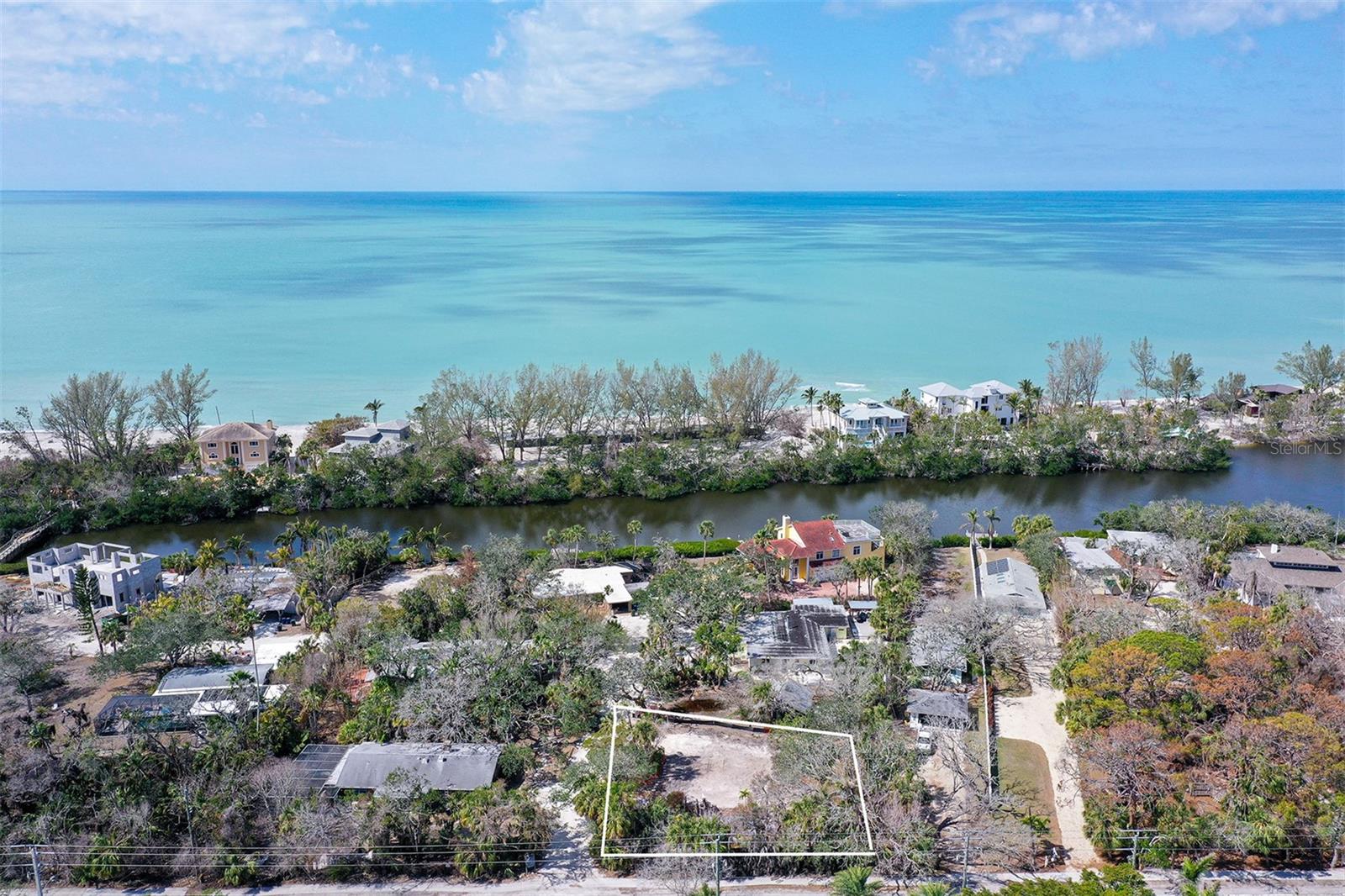 Have you ever built a bonfire on the beach and had 50 of your closest family and friends over for a beach party? This happens no where else on Siesta Key. Residents in the neighborhood enjoy the unique privilege of crossing Heron Lagoon via a private bridge to the sands of Siesta Key beach. There’s a cabana for storning your beach chairs, kayaks and water toys. It’s a one minute walk from your front door to the bridge and another minute to cross it! Here's an opportunity to build your dream home on a pristine, oversized lot nestled on the quiet end of Siesta Key. This exceptional lot offers unparalleled privacy, lush natural surroundings on an expansive corner parcel. Only minutes to restaurants, a marina to house your boat, and beautiful Turtle Beach where you can walk to newly opened Midnight Pass. The previous structure has been removed, and a clean slate is waiting for your vision. Use the Showing Time button to schedule your visit today.