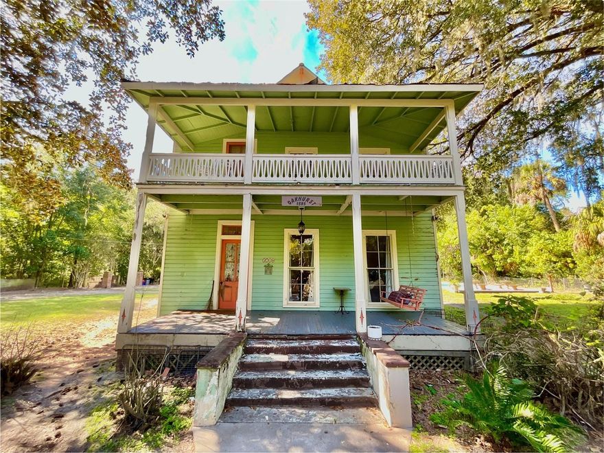 Incredible investment opportunity in historic downtown Melrose! This is your chance to own and restore *Oakhurst*, a 3-story Victorian masterpiece built in 1885. Boasting 3 bedrooms, 3 bathrooms, and 3,009 square feet of authentic craftsmanship, this home is a true testament to the architectural grandeur of its time. Situated on 1.24 acres, the property features solid hardwood flooring, 10' ceilings, and classic period details including a double fireplace, beadboard accents, clawfoot tub, and vintage light fixtures. Relax on the charming front porch swing or enjoy the 2nd-story balcony with peaceful views. The spacious layout offers oversized bedrooms, formal and informal dining rooms, and a large open kitchen. The 2014 metal roof addition provides additional living space, while the 40x40 RV-sized metal building with two bays and roll-up doors offers ample storage or workspace. A partially restored and unfinished 20x30 outbuilding with HVAC could easily be transformed into an office, studio, or guest house. The fully fenced, gated yard with an in-ground swimming pool provides the perfect setting for family gatherings or relaxation. Located just a short commute to Gainesville and Palatka, *Oakhurst* has the potential to be the crown jewel of Melrose once more, with possibilities for Airbnb or other investment ventures. Melrose water and modern amenities are already in place. This home is a rare find with endless potential—make it yours today!