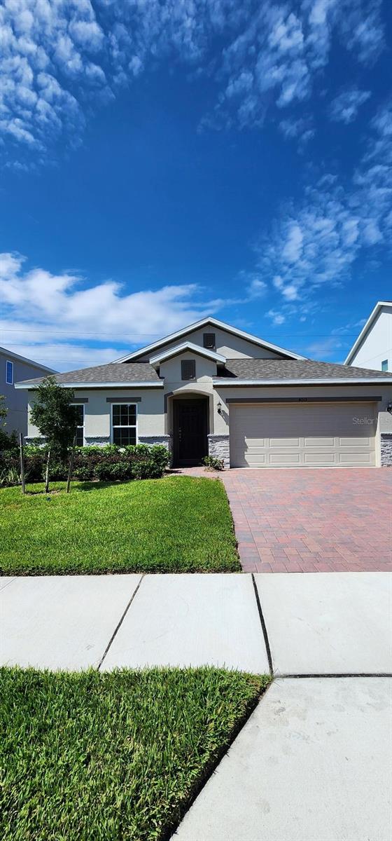 One or more photo(s) has been virtually staged. Welcome to the beautifully designed Kensington Flex plan, offering a spacious open-concept layout with a desirable split-bedroom design and a versatile Living Room/Den at the front entry. This thoughtfully upgraded home features elegant tile flooring throughout the main living areas, and a well-appointed kitchen boasting 42" white cabinetry with crown molding, quartz countertops, a large center island, and stainless steel appliances—including refrigerator. The Laundry Room is move-in ready with a washer and dryer included. Enjoy indoor-outdoor living with a generous Great Room that opens to a covered rear Lanai. The Primary Suite offers a private retreat with a luxurious en-suite bath featuring walk-in closet, dual sinks in adult-height vanity, quartz countertops, and a spa inspired shower with rain-head fixture and frameless glass enclosure. Curb appeal shines with decorative stone accents on front exterior, attractive landscaping, and a brick paver driveway and lead walk. Lake Lincoln Community amenities include a dog park, walking trail, and a play ground/tot lot with plenty of shade for the littles under a cluster of shady oak trees. Conveniently located close to schools, Publix shopping center, Target, and Walmart. Just a short 6 minute drive to the quaint downtown areas of Mount Dora & Eustis, with easy access to major thoroughfares.