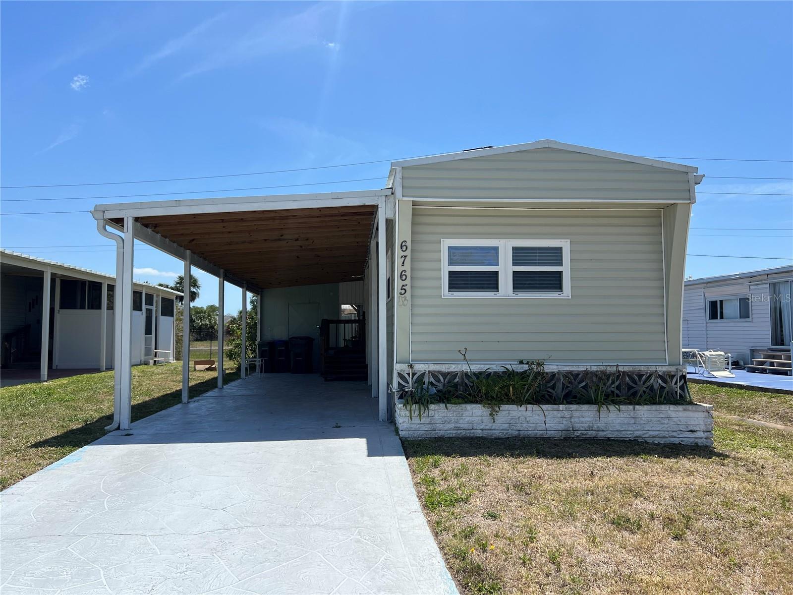 Welcome home to your Florida Retreat! Holiday Park is a desirable 55+ mobile home park that you own your land with a deed! This single wide is ready for a new owner. Mobile home comes with everything in it. No need to buy new. Mobile home is being sold As/Is. Roof was replaced in 2022, New Tie Downs added 2022, new vinyl siding in 2022, new carport 2022 also! The A/C was replaced in 2023 according to the seller. Shed was added in 2019. Holiday Park has lots to do too. Enjoy the 2 heated community pool, 3 tennis courts, 4 pickleball courts, 3 bocce ball courts, 14 shuffleboard courts, 6 horseshow pits, library, fitness center, billiards, clubhouse and if needed boat and RV parking. Lots of social activities to enjoy. Shopping, big box stores and restaurants all nearby too. The park is gated for added security. Wellen Park is only 5 minutes up the road. Wellen Park features lots of family friendly activities like outdoor concerts, fishing, restaurants, shopping and a weekly farmers market for your fresh foods. The Atlanta Braves Spring Training camp is in Wellen Park too. The famous Warm Mineral Springs is only minutes away too. Venice Beaches and famous historic Venice downtown is only 20 minutes away! You will love where you live in North Port, Florida. Call for a private showing.