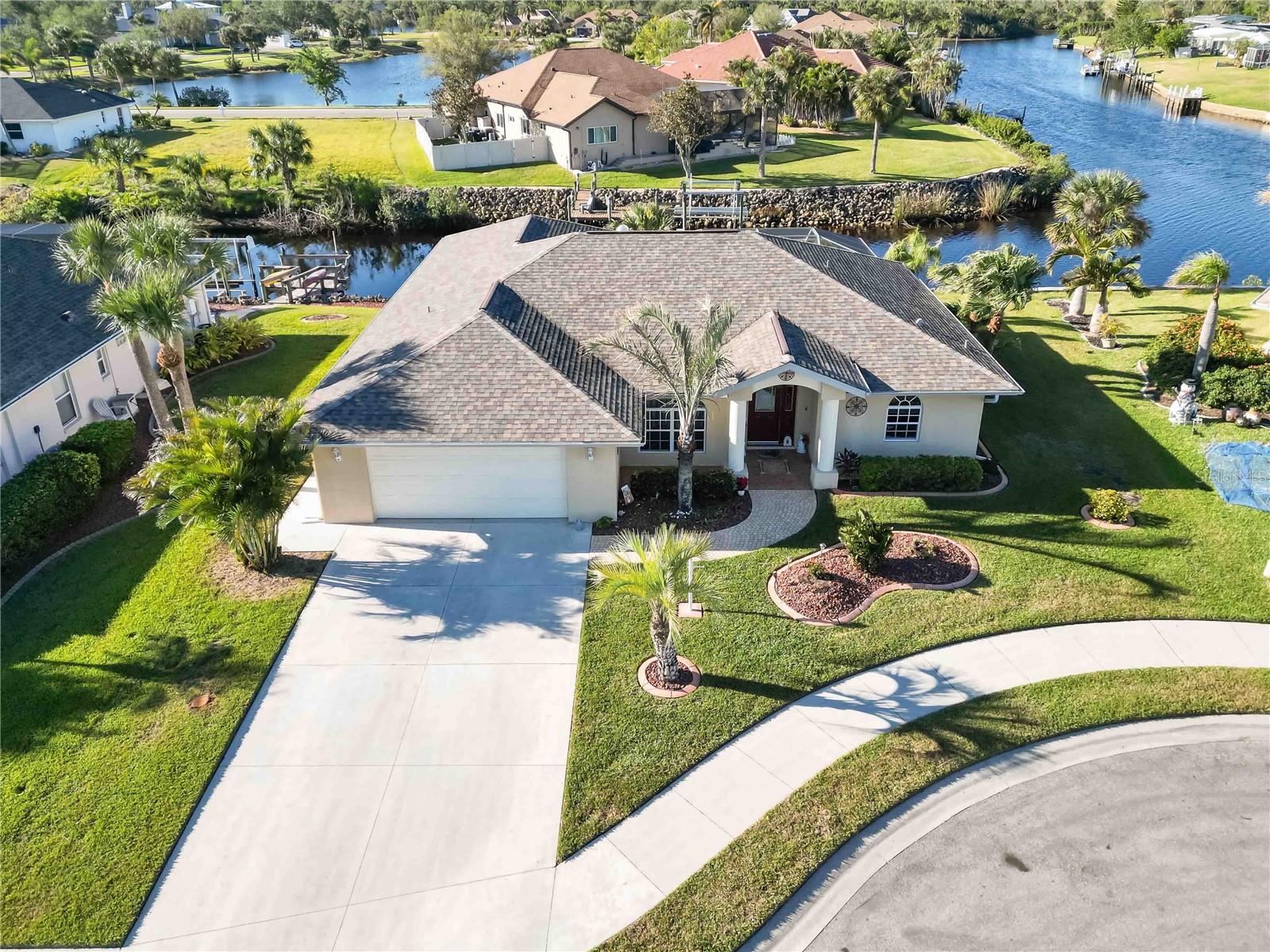 Amazing Deal Alert!!! Impressive WATERFRONT home on CUL-DE-SAC with 3 Bedrooms, 2 Bathrooms and an oversized 2 Car Garage located in the desirable deed restricted community of DUCK KEY in North Port, FL. Gulf Access through the wide canals of the Big Slough Waterway! This home exudes elegance from the moment you arrive with its mature, tropical landscape and beautiful curb appeal. As you enter the front door you will be WOWed by the custom tile entryway and architectural details. The open and split bedroom floor plan provides a Living Room, Family Room, Dining Room, and a well-equipped Kitchen. Sliding glass doors throughout lead to the large, southwest facing lanai with an extended screened in patio overlooking the beautiful water views and gorgeous sunsets. The Kitchen offers solid wood cabinets with 42-inch uppers, granite countertops, newer stainless-steel appliances including a double oven range, ample storage space, a pantry, dining area and lanai access. Just off the kitchen you will find the spacious family room that is perfect for entertaining or gathering with family. Watch TV on the custom built in wall or get cozy by the electric fireplace. The breathtaking water views continue in the Master Suite with sliding doors leading to the lanai, his and hers walk-in closets, and a private en-suite bathroom with Jack and Jill sinks and a walk-in shower. There are two additional bedrooms on the opposite side of the house with walk-in closets and a guest bathroom with outdoor patio access. ***Special features include: tile flooring throughout (no carpets), wood flooring in the primary suite, high ceilings, NEW ROOF in 2022, NEW hot water heater in 2024, freshly painted interior in 2023, NEW patio screens in 2023, entire home rain gutters, well-fed sprinkler system, rip rap seawall, and much more*** Duck Key is a quiet and peaceful waterfront community with LOW HOA fees!!! Located conveniently near dining, shopping, golf and popular local beaches. A short drive to I-75 allows for easy access north to Tampa or south to Miami. This home has the option of coming fully furnished, if desired, so all you need is your clothes and come live in Paradise!!!