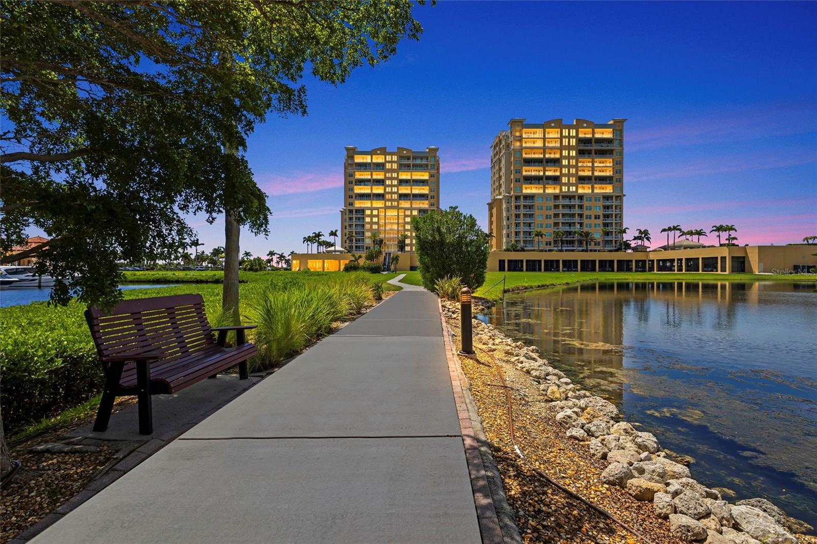 LUXURY WATERFRONT Condo with PANORAMIC RIVER VIEWS. Experience elevated coastal living in this stunning 2-bedroom, 2-bathroom CORNER UNIT condo offering 1,978 sq ft of refined space and sweeping views of the Manatee River. This residence boasts a PRIVATE ELEVATOR entrance and is perfectly designed for comfort, style, and entertaining. Inside, you'll find an updated chef’s kitchen featuring brand-new Kitchen Aid appliances, stylish backsplash, and a RENOVATED KITCHEN with new appliances and quartz countertops. A CUSTOM integrated WINE BAR with wine fridge adds a touch of luxury and convenience. Soaring high ceilings, tile and hardwood floors, floor-to-ceiling sliding glass doors, and three walk-in closets provide spacious, elegant functionality throughout. The primary suite is a serene retreat with DUAL VANITIES, a large walk-in shower, and ample closet space. Step outside onto the expansive west-facing balcony to enjoy breathtaking views and sunsets, perfect for watching the 4th of July fireworks and Bradenton Regatta. Additional features include a reserved covered garage PARKING SPACE, a climate-controlled STORAGE UNIT, and access to an extensive list of amenities such as 4 large swimming pools and hot tubs with gas grilling areas, theater room with stadium seating, billiards room, library, social room, conference room and two lobby-floor GUEST SUITES for overnight visitors. As a bonus, residents enjoy shared access to the new Palmetto Marriott BEACH CLUB, offering state-of-the-art 24 hour gym, lap pool, oversized resort pool, Pickleball courts, lawn games, and 9 hole putting green. Guest bedroom views the adjacent private Riviera Dunes Marina and popular Dockside WATERFRONT RESTAURANT with live music. This home also benefits from Palmetto Marriott Resort and Spa's outdoor concerts and events, spa and yoga classes, plus the nearly complete renovation of the convention center, promising a beautifully modernized neighborhood hub. Bel Mare is close to beaches on Anna Maria Island, Longboat Key and Lido Key, countless golf courses, IMG Academy and offers quick access to Sarasota / SRQ airport and 45 minutes to Tampa International Airport. Seller will pay 3 months Condo dues.