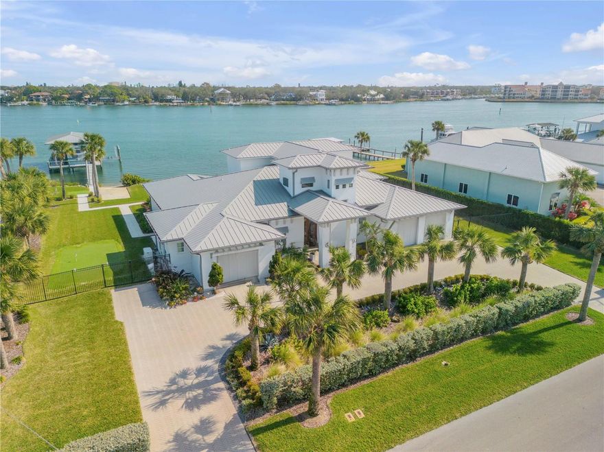 Under contract-accepting backup offers. Check out the Matterport 3D tour! Welcome to your Custom Waterfront Dream Home. This exquisite waterfront property offers the perfect blend of luxury and comfort, designed with an open-concept layout that maximizes natural light and stunning water views. A spacious downstairs master suite serves as your personal retreat, complete with his-and-her walk-in closets and a massive spa-inspired bathroom featuring a large walk-in shower and a soaking tub. You'll never want to leave this serene sanctuary. In addition to the master suite, the home boasts three spacious guest bedroom suites, each offering ample space and privacy. An office, which can easily serve as a fifth bedroom, provides flexibility to suit your needs—whether for work, guests, or a quiet space of your own. The heart of the home is the beautifully appointed chef’s kitchen, complete with a generous island and top-of-the-line appliances, making it perfect for preparing meals and entertaining family and friends. The open-concept living area flows seamlessly, creating an inviting space that feels as though it’s part of the surrounding natural beauty. Step outside to your expansive covered porch, where you can fully embrace the salt life. With another large dining and living area, this space is ideal for relaxation and entertainment. Enjoy evenings bug-free, thanks to automatic screens, while taking in the serene surroundings. The saltwater pool offers refreshing views of the Intracoastal Waterway, and the outdoor shower and kitchen make alfresco living a breeze. The spacious yard features endless options for fun, including a bocce ball court, chipping area, and putting green. For boating enthusiasts, this property is a dream come true. Two separate docks, including a 25k-lb lift, a 12k-lb lift, and a private boat ramp/launch, provide unparalleled access to the water. Additional highlights include a ten-car driveway, three-car garages, a 22kW generator, and a commercial-grade ice maker. Located just a short walk, bike ride, or golf cart ride across the bridge to Flagler Ave’s vibrant shops and restaurants, as well as the world-renowned shores of New Smyrna Beach, this home offers a lifestyle like no other.