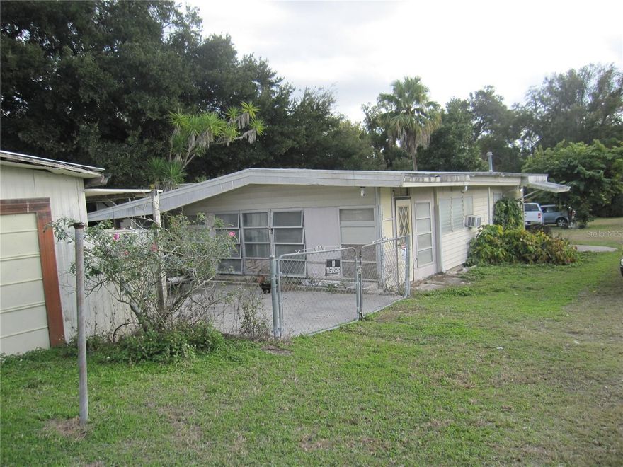 INVESTOR ALERT!!   This 1/3 acre fixer upper presents a prime investment opportunity for those looking to build equity in a peaceful country setting. The property is centered around a spacious double wide manufactured home that is ready for a full renovation to suit your vision. In addition to the main residence, the lot features two separate shop or garage structures that offer incredible versatility for storage, hobbies, or workspace. One of these additional structures is already equipped with washer and dryer hookups, providing extra utility and potential.

The land itself is a standout feature, adorned with beautiful mature oak trees that create a shaded and private atmosphere. The land and impact fees saved are worth the asking price.  Despite the ruralfeel, the location is exceptionally convenient.  You are situated within one mile of major Zephyrhills shopping centers, including Walmart, Publix, and Lowe's, ensuring that supplies for your renovation are always just a few minutes away.

This property is being sold cash only due to its current condition. Whether you are looking for a flip project, a rental investment, or a custom home site with plenty of room for tools and toys, this lot offers the space and location to make it happen.