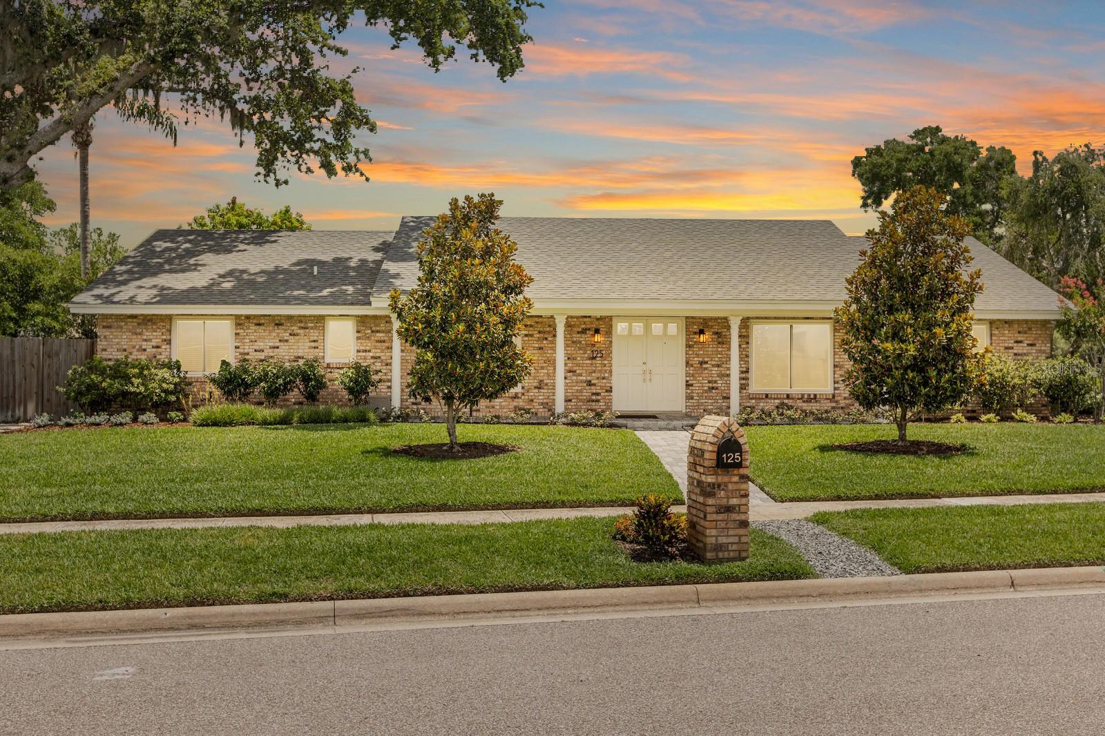 One or more photo(s) has been virtually staged. Welcome to 125 White Oak Circle—a rare opportunity to own a beautifully renovated 4-bedroom, 2.5-bath home offering 2,524 square feet of refined living space in one of Maitland’s most peaceful and desirable neighborhoods. Tucked near the tranquil shores of Lake Sybelia, this meticulously maintained 1/3-ACRE CORNER-LOT residence combines timeless charm with modern luxury. The lot is thoughtfully balanced, offering generous space in both the front and fully fenced backyard. From the moment you arrive, the pride of ownership is unmistakable. Extensive updates offer peace of mind and lasting value: NEW ROOF (2019), NEW PELLA WINDOWS with hurricane-rated frames (2022), new garage door (2022), NEW ELECTRICAL PANELS (2022), exterior paint (2019), FULL REPIPE (2019), all new electrical outlets and rocker-style switches, added attic insulation, updated irrigation and Provista St. Augustine sod (2022), epoxy garage floor, and upgraded laundry with LG front-load washer and dryer set on pedestals for convenient storage. The garage also includes a full-size refrigerator. The home’s stately brick façade, double entry doors, and paver walkway are framed by lush landscaping—including magnolia trees, a mature oak, Japanese blueberry, pygmy palms, pines, and more. Curb appeal is just the beginning. Inside, you’ll find wide luxury vinyl plank flooring throughout, 5" baseboards, 4" door casings, crown molding, and solid cedar interior doors. The spacious bedrooms offer comfort, and the home provides abundant closet storage throughout—perfect for keeping everything organized and out of sight. The gourmet kitchen is a showstopper—fully remodeled with custom cabinetry to the ceiling, quartz countertops, a designer backsplash, matte black hardware, and high-end Bosch appliances (including refrigerator, dishwasher, and range hood), plus a GE induction cooktop and oven. The bathrooms have been completely updated with stylish vanities, new fixtures, tile, and toilets. The primary suite includes an oversized walk-in shower, offering a spa-like experience. The family room features a cozy brick wood-burning fireplace, while the formal living and dining rooms provide the perfect space to gather. A light-filled enclosed Florida room adds flexibility—ideal for a home office, playroom, or additional lounge space. Step outside to your private, fenced backyard oasis—perfect for relaxing under swaying trees and blue skies, or entertaining on the paver patio. Located just across the street from Orangewood K–12 private school and near the neighborhood’s Lake Sybelia Elementary, this home is a dream for families. Enjoy serene walks to Lake Sybelia’s park—complete with a playground and fishing dock—or take a quick bike ride to Independence Lane and Lake Lily for Sunday farmers markets, community events, and local dining. With quick access to I-4, you’re just minutes from everything Central Florida has to offer—yet nestled in a quiet, tree-lined enclave that feels worlds away. This turnkey residence blends thoughtful design, quality craftsmanship, and a prime location for a truly exceptional lifestyle. Don’t miss this opportunity—schedule a showing today!