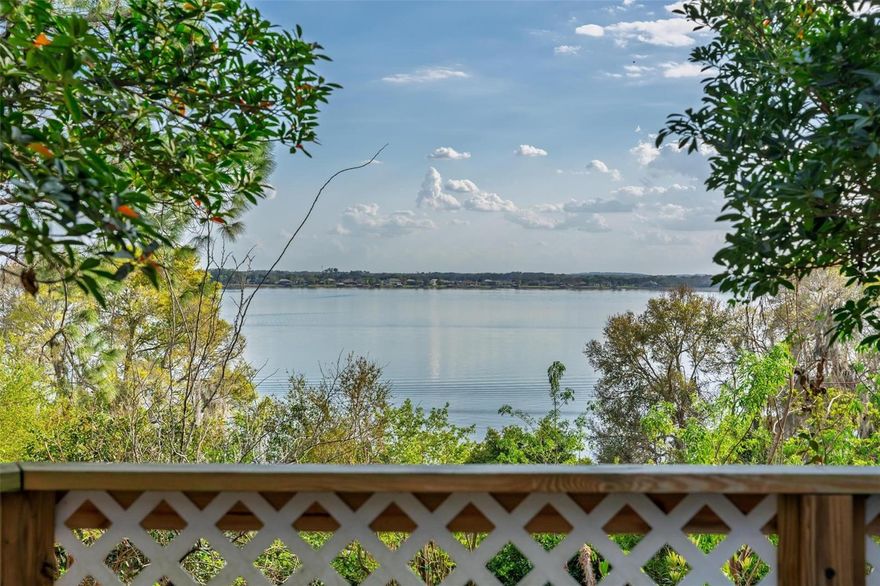 *PRICE IMPROVEMENT*A rare opportunity to own a magnificent .85-acre lakeshore estate on the famous shores of Lake Dora. Over 5,000 sq. ft. of living space and more than 200 ft.of pristine lake frontage,this completely renovated Cape Cod offers a lifestyle of luxury, breathtaking sunset views, & unparalleled flexibility.Arrive through a tranquil zen garden with a peaceful pond & choose between two inviting entrances.Step inside to a timeless foyer, where stained-glass windows and an elegant chandelier cast a warm glow, leading you into a dramatic hallway that hints at the classic craftsmanship throughout.This multi-story home is designed for both grand entertaining and intimate daily life.Features 3 bedrooms and 3.5 bathrooms,with with room to expand, you're also protected by a whole home generac generator .The main level includes a bespoke Library, anchored by a wood-burning fireplace and a wall of windows overlooking the lake.This space,which was the original  1st floor primary suite,can easily be reconverted with its en-suite bath and private entrance to serve as a 4th bedroom or a private mother-in-law suite.The award-winning chef's kitchen is a dream,featuring Wolf and Sub-Zero appliances,a multi-functional island with a gas wok burner and refrigerator drawers,two warming drawers,and handcrafted hickory cabinetry.Adjacent to the kitchen, a sunlit breakfast nook overlooks the grounds,while a formal dining room provides the perfect setting for dinner parties and holiday gatherings.The heart of the home is the unforgettable Great Room.Exposed beams and a striking floor-to-ceiling stone fireplace with a grand mantel are framed by a massive 22-foot picture window,capturing postcard-perfect views of Lake Dora.For more formal gatherings,the elegant living room, known as "The Red Room," offers a second wood-burning fireplace and timeless charm.Step onto the large circular wooden deck to watch spectacular sunsets over the water.Below, discover your own curated edible landscape,a sanctuary garden brimming with fruit trees, fresh herbs,& dedicated greenhouse for the avid gardener.Additional private decks and a large front balcony overlooking the zen garden provide quiet spots for morning coffee or evening reflection.The grand basement reveals a remarkable climate-controlled cedar wine cellar and an exceptional bar and entertainment lounge.This space is complete with a cooktop, dishwasher, and a luxurious bathroom with a double vanity and a walk-in travertine shower with a rain-shower head.With its own entrance, this level is ideal for guest quarters, a rental apartment, or the ultimate entertainment lounge.(Note: The lower level's square footage is in addition to the public record of 4,151 sq. ft.)A 115-square-foot art studio off the Library, equipped with a sink, is perfect for a workshop, hobby room, or creative space.· An additional 500 sq. ft. of finished attic space presents an opportunity to add even more value, bringing potential living space to nearly 5,500 square feet.The property comprises two waterfront parcels. This offers the unique potential to retain a sprawling legacy compound or, with the appropriate city approvals, explore the possibility of a future build site, a concept already met with positive feedback from the City of Mount Dora Planning department.This is more than a home;it's a waterfront sanctuary where classic elegance meets modern luxury, just waiting for its next chapter. See attachments for survey and floor plans