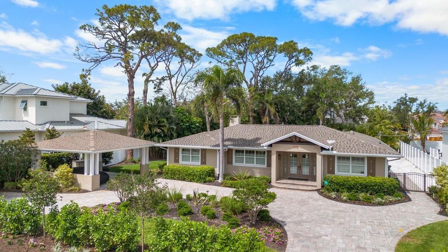 This revitalized 2,550 sq' (+/-) single level home is in coveted Harbor Acres and within walking distance to the quaint Southside Village, Sarasota Bay and the energizing downtown area. Bistros, gourmet markets, art galleries and all things exciting will be yours to explore. With remodeling beginning in 2016 to Miami Dade Hurricane code regulations, improvements include the addition of a 750 sq' (+/-) Primary Suite with full bathroom for one and a 3/4 bath for another, both with walk-in closets thru-outs, modern lighting and plumbing fixtures, refurbished oak flooring, granite counters, security system, whole-house stereo speakers, new appliances, 426 sq' screened porch for outdoor entertaining, paver circular driveway with additional parking pull-outs, landscaping and dramatic lighting and a custom made art piece which is also an outdoor water feature. A new roof completed the project in 2022. The plan features a living area, separate dining room and kitchen in the center of the home, which separates the primary bedroom from the additional 2 bedrooms, for privacy. There is a storage building for outdoor accessories, a roomy 2-car, solid structure carport, water well for the sprinkler system and spray foam insulation in the attic. New HVAC, including duct work and UV light filter 2026.  Not too big, not too small, no elevators, no shared parking, optional HOA dues of $125 a year and a one-of-a-kind opportunity, in a once in a lifetime location.