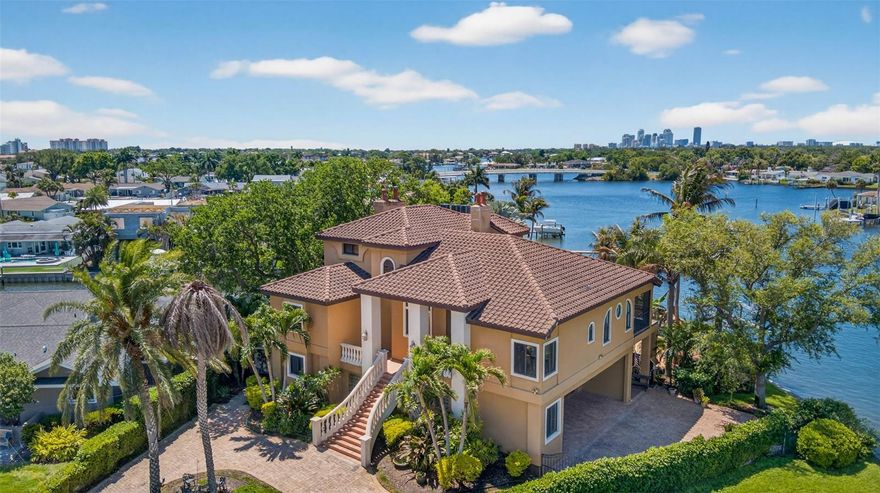 One of a kind legacy home located at the end of a cul-de-sac in the desirable waterfront community of Waterway Estates. Indoor outdoor living is seamless and with over 4,000 sq feet of generous living space and jaw-dropping waterviews from nearly every room in the house it wont take long to see why this property is so special.  From all 3 levels, you can see the impressive skyline of Downtown St. Petersburg and wide open waterway making this a truly rare combination that is hard to come by at this price. This home truly embodies waterfront living at its finest. A grand staircase greets you on the main living floor with Mexican tile floors and high ceilings. The living room, dining room, kitchen, and family room all flow from one to the next with defined spaces for each. The expansive balcony and patio will be your favorite place to enjoy the Bay breeze and evening meals while you watch the sunset and the dolphins and manatees play in your backyard. 5 total bedrooms, 4 full bathrooms, an oversized 2 car garage with vaulted ceilings and a large bonus lock and go storage/work station or man cave. Many quailty improvements have been made over the years including but not limited to hurricane impact windows and doors, newer HVAC (regualry maintained), a resort styled pool, large grandfathered dock with boat lift, replaced seawall and tiled roof. This home is a solid fortress that has withstanded the most recent hurricnes without any water intrusion or damage even the pool was not effected. The top floor of the home is an impressibe 1,000 square feet of primary bedroom bliss. A reading nook, morning/coffee station with a wet bar, and private balcony with his and her walk-in closets, a soaking tub, shower, and dual vanities the space is hard to leave. The lower level of the home is an entertainers dream. Gracious living space perfect for poolside gamedays with a seperate large bedroom and full bathroom just steps from the pool and garage. A truly exceptional residence in one of St Pete’s most desirable locaions a golf cart or bike ride away from Downtown, 20 min to our World famous beaches, and 25 min to two international Airports. Come see why so many choose to call St Pete home.