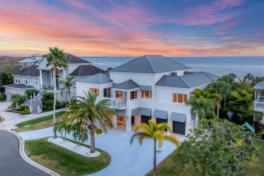 Elegance meets waterfront luxury in this unparalleled Sarasota Bay residence, a masterpiece of refined living.  Situated at the end of a tranquil cul-de-sac within the exclusive gates of Esplanade on the Bay, this waterfront home is a testament to opulence.  The current owner has invested $250,000 in enhancements, transforming this already breathtaking home into a haven of sophistication, and stylish, high-end furniture is included. Upon entering the grand foyer, prepare to be captivated by sprawling 180-degree bay views through accordion folding glass doors and accentuated by soaring ceilings.  The living room opens to an expansive terrace that spans the entire length of the residence to the family room and the owner’s wing, creating a seamless indoor/outdoor living experience.  The custom gourmet kitchen is a culinary enthusiast’s dream, boasting a quartz island with ample seating, a glass induction cooktop, Miele appliances, and a wine and coffee bar.  The family room, featuring a linear electric fireplace clad in stone tile, adds warmth and charm to this culinary haven. The owner’s wing is a tranquil escape, offering a sitting area, sliders to the terrace, two walk-in dressing rooms with built-ins, and a remarkable en-suite bath with a soaking tub and walk-in rain shower. A spiral staircase leads to the crow’s nest, used as an office with built-ins, that offers breathtaking views of Sarasota Bay and Longboat Key. Designed for both grand events and quiet solitude, this home features flexible spaces on the ground level, including a lounge with an electric fireplace, game room, bars and kitchenette, in-law suite, and easy access to the pool deck.  The backyard is a tropical paradise with a custom pool featuring two 15-meter lanes, a spa, and a swim-up bar. A stone path meanders through protected mangroves to a composite deck, offering a serene spot to fish, watch manatees and dolphins, kayak, and paddleboard. Luxurious finishes, including chandeliers and chrome hardware, embellish every corner. A beefed -up security system, refurbished AC systems, and a new metal roof (2020) ensure peace of mind. The home also boasts a new Miele refrigerator and dishwasher, a refurbished BBQ and ice maker, three fridges, custom closets on the lower level, and over $120k in landscape redesign.  With an oversized 3-bat garage, an elevator connecting all three levels, and a design that seamlessly blends indoor and outdoor living, this home is the epitome of coastal luxury, where every detail has been meticulously curated for an extraordinary living experience.  The community is a 5-minute drive to IMG Academy, IMG Golf Club, grocery shopping and restaurants.  Under 30 minutes to beaches, downtown Sarasota, SRQ Airport, and UTC Mall.