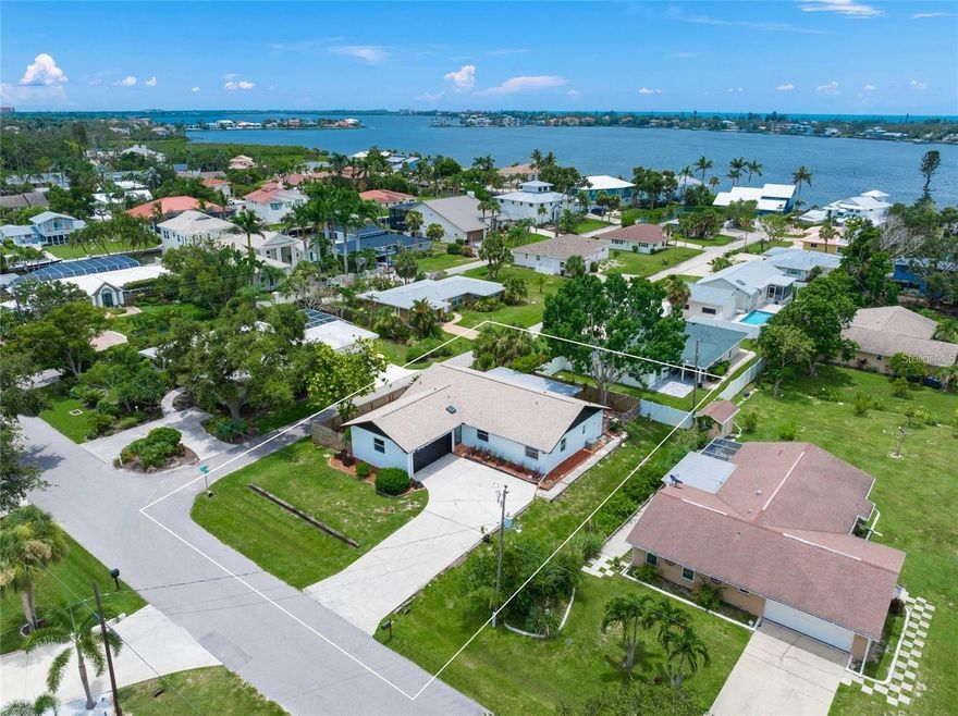 One-story coastal home within 2 miles  to Siesta Key Beach and Little Sarasota Bay, located West of the Trail off Stickney Point with no HOA, CDD or monthly fees. Positioned to enjoy convenient access to Sarasota’s beaches, dining, and downtown amenities, this home was built on an large, elevated corner lot and has been thoughtfully updated throughout.Neighborhood is a gem! Home is tucked-away, quiet with limited traffic and wide streets, yet easy access to all Sarasota has to offer.

The home features an open floor plan with abundant windows that provide natural light throughout. Home is built with block, offers an oversized 2 car swing garage and  Recent improvements include impact windows 2025, roof 2024, new sliders, fresh interior paint, new luxury vinyl plank flooring, updated baseboards, solid wood interior doors, and new lighting including recessed and fixture lighting.

The gourmet kitchen has been completely redesigned and includes new custom cabinetry with soft-close drawers, a newly added pantry, quartz countertops, stainless steel appliances, a single-side stainless sink, vaulted ceilings, and a tiled backsplash. The kitchen opens to the dining and living areas, offering a functional and efficient layout for daily living and entertaining.

Both bathrooms have been fully renovated and feature tiled showers with glass enclosures, updated cabinetry, modern fixtures, designer masonry, mirrors and lighting. The primary bedroom offers sliding glass door access to the lanai, newly installed windows, and updated finishes.

Outdoor living areas include a covered screened lanai, open-air wood decking, and paver patio areas suitable for outdoor seating and entertaining. Additional features include a water softener, UV germ light in the HVAC system, a hot water recirculation system, and a recently passed plumbing inspection.

Conveniently located near Southside Village, downtown Sarasota, Bayfront Park, Sarasota Yacht Harbor, fine dining, theater, the opera house, St. Armands Circle, Lido Key, and Longboat Key and Sarasota Bradenton Airport. Zoned for Gulf Side Elementary School. Suitable as a primary residence or secondary coastal home.