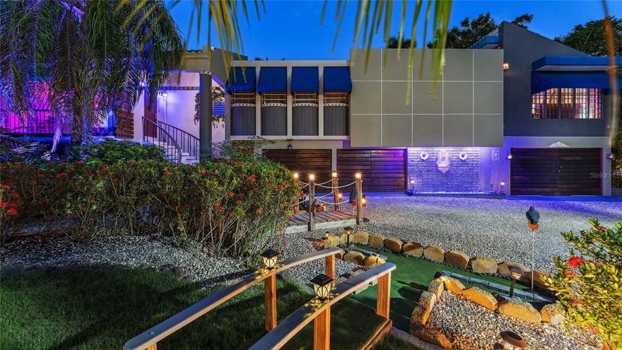 A bespoke, fully furnished Caribbean estate offers an extraordinary opportunity along Rincón’s famed “Road to Happiness,” where complete privacy meets elevated resort-style living. Artistically designed with custom natural stone and wood finishes, this one-of-a-kind property spans a lush landscape of koi ponds, curated gardens, and immersive water features, all just moments from the beach. Seven bedrooms each with a dedicated bathroom, a waterfall pool with glowing lava pots, and a host of unique amenities—including a wine cave, speakeasy, and rum tasting casita—set the stage for unforgettable entertaining. A chef’s kitchen, artisan garage, game room, and outdoor sports courts complete the estate’s extensive offerings. Thoughtfully concealed by mature palms and 360-degree landscaping, this self-contained oasis is both serene and accessible, very close  to world-class surf, fine dining, and Puerto Rico’s vibrant west coast lifestyle.