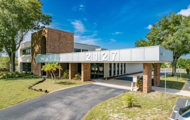Excellent investment opportunity featuring TWO STRONG TENANTS. The STATE OF FLORIDA (DEPARTMENT OF CHILD SUPPORT SERVICES) occupies 8,882 SF with approximately THREE YEARS REMAINING ON THE LEASE and has expressed interest in EXTENDING FOR 10+ YEARS. The CURRENT OWNER OCCUPIES 6,880 SF and is open to STAYING OR VACATING based on the buyer’s needs. Additionally, 7,040 SF OF VACANT OFFICE SPACE is available for lease.
The property also includes a 1,512 SF SINGLE-FAMILY HOME, currently occupied, which can provide ADDITIONAL RENTAL INCOME. Recent improvements include NEW ROOF (2023), EXTERIOR PAINT (2023), and UPDATED CARPET & INTERIOR PAINT in the State’s office suite.
TOTAL CURRENT GROSS INCOME: $261,197 ANNUALLY, with potential to increase through lease-up of the VACANT OFFICE SPACE and RESIDENTIAL UNIT.
Situated on a 4.77-ACRE C-2 ZONED LOT, the property offers approximately 133 PARKING SPACES and excellent potential for OUTSIDE STORAGE OR EXPANDED COMMERCIAL USE.
Ideal for a variety of users, including MEDICAL OFFICES, PROFESSIONAL SERVICES, or SERVICE-BASED BUSINESSES such as ELECTRICIANS, PLUMBERS, AND HVAC CONTRACTORS — especially those needing AMPLE PARKING OR FLEXIBLE OFFICE SPACE