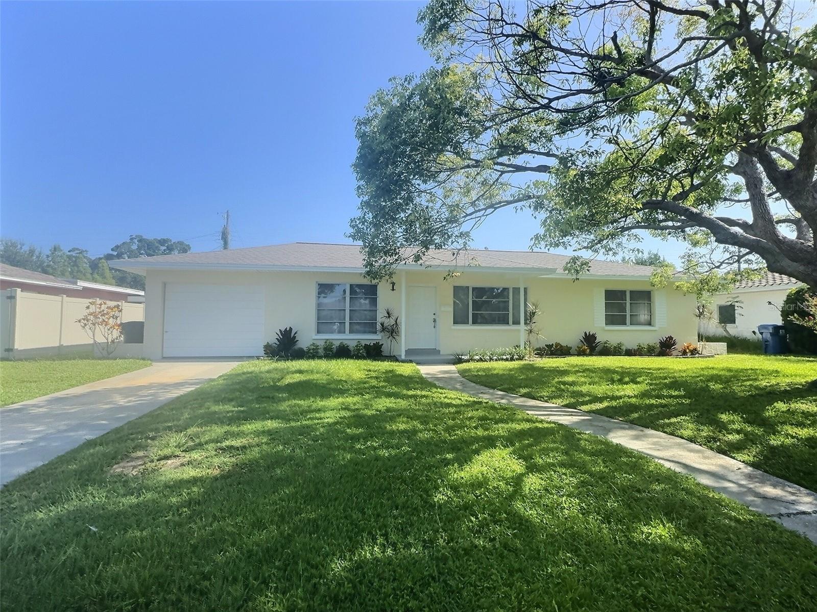 Welcome to this stunning 2-bedroom, 1.5-bath Mid-Century masonry block home, located in the heart of St. Petersburg’s desirable Harshaw neighborhood. Solidly built with 1950s craftsmanship and updated with modern finishes, this home blends Old Florida charm with thoughtful upgrades throughout.
Step into the living room and enjoy gleaming original terrazzo floors, coved ceilings, plaster walls, and updated baseboards. The kitchen features granite countertops, soft-close wood cabinets, and brand-new Whirlpool stainless steel appliances. Adjacent is the dining area with a new mid-century modern light fixture, connecting seamlessly to the living and kitchen spaces.
The full bath is a showstopper—a completely reimagined retro “Mamie Pink” oasis featuring basketweave tile floors, a vintage-inspired console sink with chrome legs, stylish chrome hardware, and integrated vertical bullet sconces flanking the medicine cabinet mirror. A brand-new half bath has been added to the laundry area inside the oversized one-car garage.
Both bedrooms are carpeted, but original terrazzo lies underneath. Additional updates include new tile flooring in the kitchen and hallway, fresh interior and exterior paint, and updated landscaping in both front and backyard.
Enjoy Florida living from the spacious screened-in lanai overlooking a beautifully manicured backyard. A large shed provides extra storage, while the garage offers overhead storage and room for most vehicles.
Built with classic Florida craftsmanship—plaster walls, coved ceilings, decorative stucco shutters, and an arched kitchen pass-through—this home reflects the enduring quality of its era.
Located in Zone X—no flood insurance required—and in a non-evacuation zone, this home offers peace of mind with excellent proximity to US-19, I-275, downtown St. Pete, Tampa International Airport, Gulf beaches, Sarasota, and nearby parks and shops.
Perfect for first-time homebuyers, downsizers, or anyone who appreciates mid-century architecture with modern updates—this home is move-in ready and waiting for you.