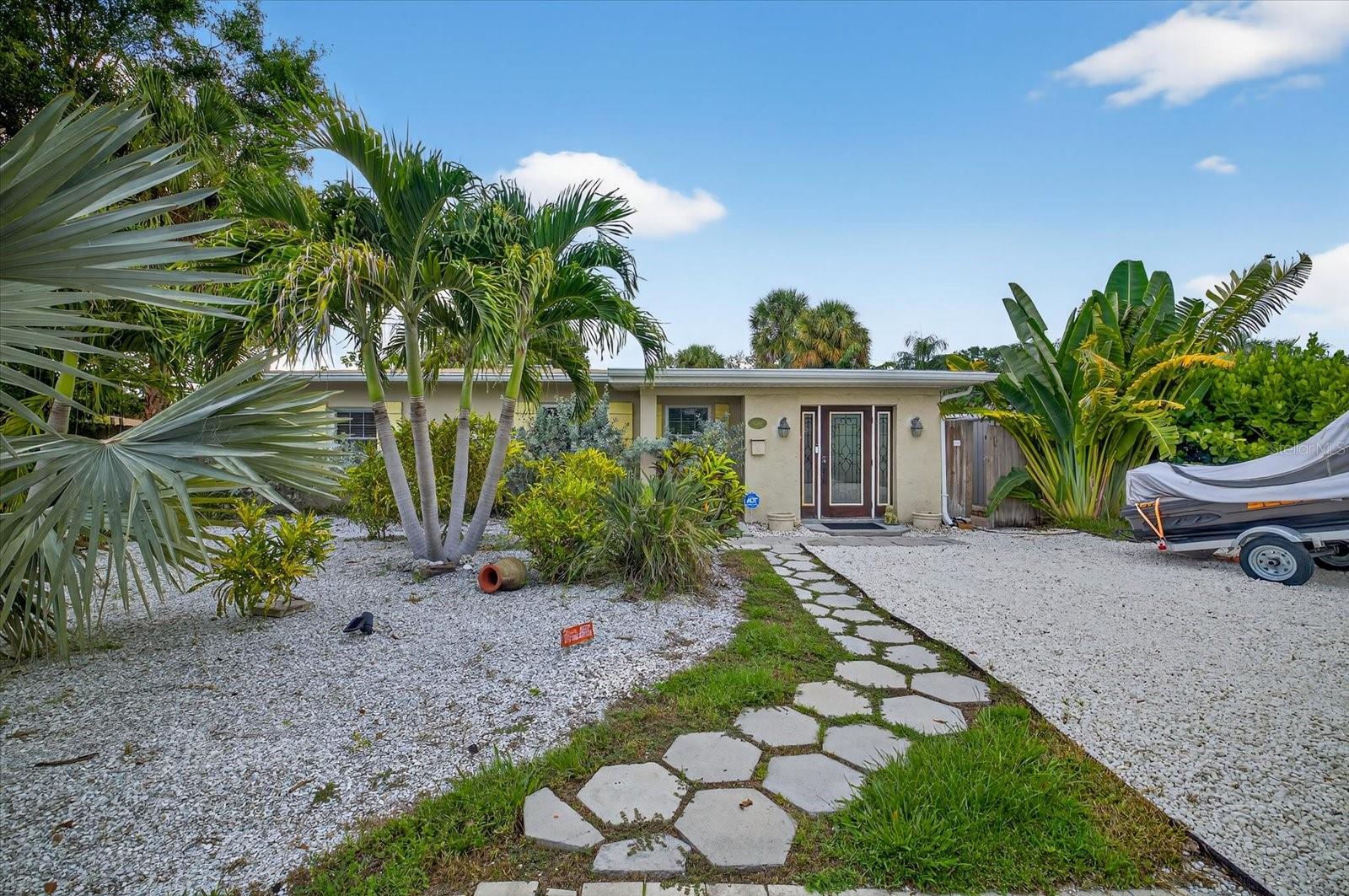 Located in the desirable Pasadena Estates neighborhood, this updated 2-bedroom, 2-bathroom home includes a detached in-law suite with its own private entrance, 1 bedroom, 1 bathroom, and a full kitchen. Just minutes from St. Pete Beach and a short drive to downtown St. Petersburg, the location offers convenient access to shopping, dining, parks, and public transportation. The main home features updated flooring, a refreshed kitchen, and modernized bathrooms. The outdoor space is perfect for entertaining, with a spacious patio and heated inground pool surrounded by newly landscaped grounds. Energy-efficient upgrades include fully paid solar panels (installed 2021), a 2020 roof with insulation, and a new HVAC system installed in 2023. Offering comfort, flexibility, and a prime location, this property is ready to enjoy.