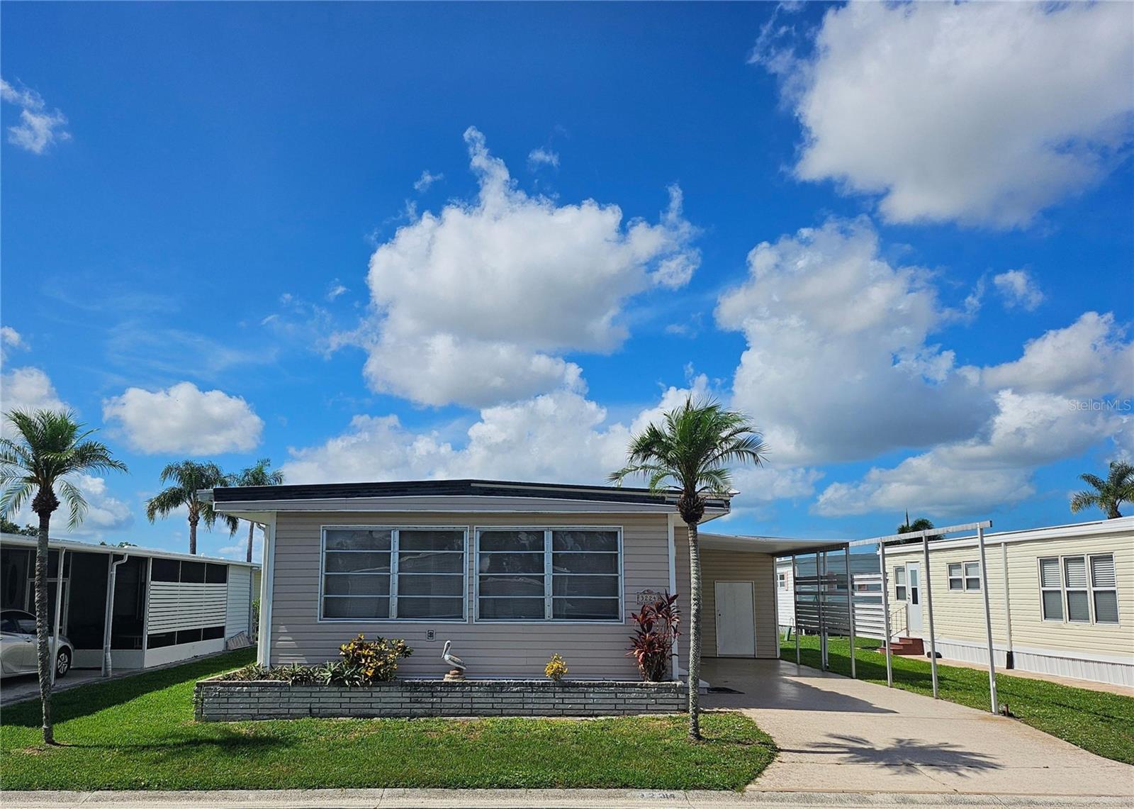 Located in the ONLY Resident Owned Park in the City limits of Sarasota!! - on a lot close to the Amenities and both gate accesses. Enter thru the front Florida room or kitchen to this turnkey furnished 2 Bed 2 bath home. The Florida room has been opened partially to the main living space, AC vented and the floor has been raised to same level as the home. This is a great space for additional overnight guest, creating a reading nook, hosting game night or working out a great puzzle. The living room has 2 large recliners, a flat screen tv and 2 nice full size sofas with one housing a sleeper sofa for the occasional extra overnight guest or grandkids. The dining room has an oval table/castor seat set and built in server with added storage space. This kitchen features stainless appliances, lots of storage cabinets and a pantry. The primary bedroom has a queen set ( with plenty of room if you prefer a king ), built in closet/storage and the ensuite bathroom has an updated step in shower. Bonus: off the hall is a very large walk in closet/storage room. The guest bedroom has a trundle set and double bed, built in closet and dresser. The 120sf shed houses the washer/dryer, utility sink and ample storage space.
Updates/Extra info: Metal Roof Over, Vinyl Siding, GE panel inside, Plumbing pvc with shut offs, Sewer line replaced 2019, AC 2017 - working great, windows original. NOTE: approximately 1/2 the carport is missing and buyer is required to have the carport replaced per the HOA.
The gated 90 acre community boasts a low maintenance fee with its vast amenities starting with the spacious Clubhouse outfitted with a full commercial cook kitchen, event stage, audio/visual, dance floor, state of the art fitness room, activities hall, library with books/movies/puzzles and a pool table. Outside recreation includes an extra large heated pool with a handicap ramp, a spacious kidney shaped hot tub, ample umbrella tables and lounge chairs and updated shower rooms. Oak trees shade the beautiful park area, picnic tables and a community grill. Additional amenities to enjoy are the community putt putt course, bocce ball, ping pong, horseshoes and corn hole. Oakwood Manor is a vibrant community with numerous social events and activities. Conveniently located adjacent to Legacy Trail and 12 newer pickle ball courts. Just a short drive to our crystal sand beaches, downtown area, the marina, fishing pier, local golf courses, shopping, variety of restaurants, the museum, SRQ airport, SMH and Doctors hospitals. Please note that Oakwood is a 55+, no pet, no motorcycle Park.