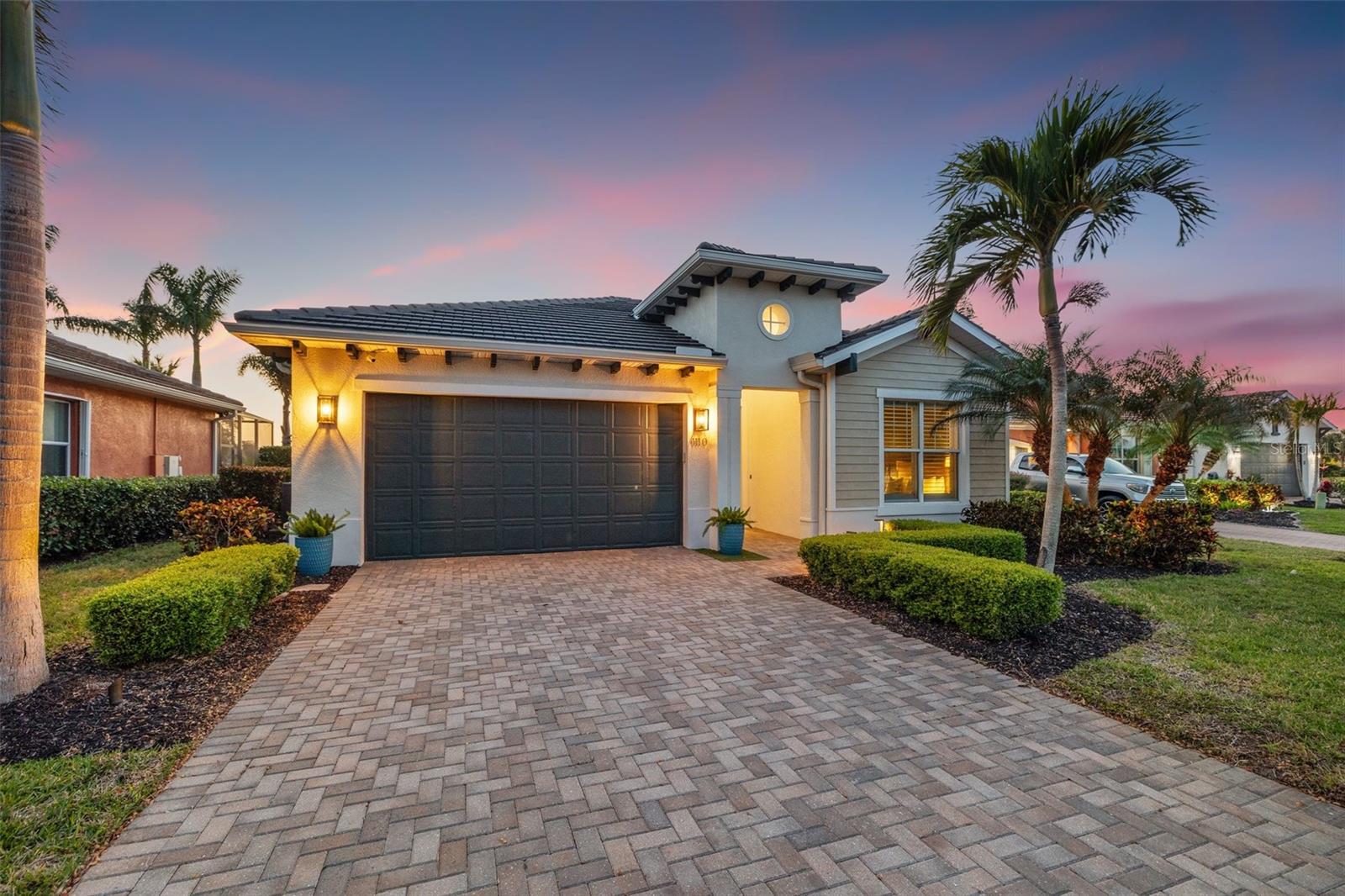 Seize this rare opportunity to embrace the ultimate Florida lifestyle in an exceptional, fully turn-key waterfront retreat. Located in the exclusive, gated Tidewater Preserve community, this meticulously designed residence offers breathtaking sunset views, direct boating access, and luxurious finishes throughout.
All furnishings are negotiable, and the home can be purchased partially or fully furnished for a move-in-ready experience—ideal for those seeking convenience, a second home, or a seamless transition to Florida living.
Perfectly positioned on a premier homesite, the home boasts a private dock and 14,000lb lift on the 55-acre Tidewater Preserve Lagoon, providing seamless access to the Manatee River and Gulf of Mexico, making it a true boater’s paradise. The location is equally convenient for everyday living, with fine dining, upscale shopping, and the vibrant arts scenes of Sarasota and Tampa just minutes away.
Inside, this beautifully curated home features four spacious bedrooms, each with its own private ensuite bathroom, along with thoughtfully upgraded interiors and gourmet indoor and outdoor kitchens designed for effortless entertaining. The chef’s kitchen is a masterpiece, showcasing an oversized quartz island, solid wood cabinetry, and a striking marble tile backsplash. Top-of-the-line appliances include a Wolf dual-fuel range with a whisper-quiet hood and three Sub-Zero refrigeration units—two full-size refrigerators and a full-size freezer. A butler’s pantry and walk-in pantry provide ample storage, ensuring both style and functionality.
Designed for both comfort and peace of mind, the home includes impact windows and doors, a whole-house generator, and a water filtration system. The outdoor living space is equally impressive, featuring a custom floating outdoor kitchen on the lanai, complete with a built-in Blaze grill, griddle, and soft-close drawer. The heated pool offers year-round enjoyment, surrounded by lush landscaping that enhances the sense of privacy and tranquility.
Upstairs, a versatile bonus suite with built-in double queen beds provides the perfect space for guests, in-laws, or a private retreat. With unparalleled craftsmanship, a prime waterfront location, and resort-style amenities, this once-in-a-lifetime property is sure to impress. HOA fees include full yard and irrigation system maintenance, internet, and cable.