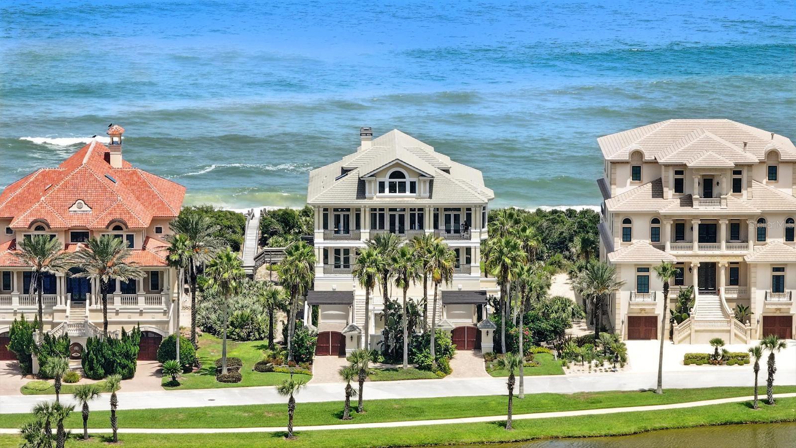 DIRECT OCEANFRONT LIVING - THE PINNACLE OF OCEANFRONT LIVING
This stunning seaside dream home is one of the most magnificent oceanfront estates. Located in the highly desirable Playa del Sur neighborhood within the Hammock Dunes Private Oceanfront Community, the property features expansive homesites with 100 feet of frontage along the Atlantic Ocean, showcasing a pristine coastline.
As you drive down Calle del Sur, the impressive collection of homes, with the Atlantic Ocean at the rear and the sparkling Lake San Gabriel at the front, will captivate you. All rooms in the house provide glorious views of breathtaking sunrises and sunsets, thanks to large windows and sliding doors. This home is being offered fully furnished, allowing for immediate enjoyment of coastal living. Each room is exquisitely appointed with rich furnishings and decor, designed to take advantage of the beautiful ocean vistas, featuring numerous windows and doors equipped with both motorized and manual shades.
Upon entering the main level, you are greeted by open views and exquisite marble flooring that continues up the elegant staircase. This floor includes a lavish sitting/studio room, a media room, an oceanfront balcony, and three en-suite bedrooms.
The second level boasts a true gourmet kitchen with incredible ocean views from every angle. It is equipped with top-of-the-line GE Monogram appliances, including a refrigerator, a standalone freezer, an oven, a microwave with a warming drawer, a six-burner range, two dishwashers, a wine cooler, a pot filler, and a walk-in pantry complete with a laundry chute. The dining room offers stunning views of the lake, while the living room, filled with ocean views, features a fireplace and a bar. The oceanfront primary bedroom on this level comes with triple sinks, ample cabinets, and spacious walk-in closets.
The top level includes a fireplace, an office, a living room bar, a refrigerator, a full bath, and a sitting area overlooking the lake, making it perfect for a guest suite.
A special highlight is the cabana on the first level, featuring a full wall of sliding doors that open to the courtyard-style pool and spa. It is equipped with a kitchen that includes a refrigerator, dishwasher, sink, oven, and a full bath.
The spacious, air-conditioned garage can comfortably accommodate up to seven cars and provides plenty of storage space.
Membership to the award-winning Hammock Dunes Club is available, though not mandatory. This membership grants access to two renowned Audubon-certified 18-hole golf courses, two stunning clubhouses, casual and oceanfront dining, tennis, pickleball, bocce, oceanside croquet, a state-of-the-art fitness center, an oceanside pool and spa, a splash pad, and a wealth of activities and friendships that can last a lifetime.
Conveniently located just three miles from I-95, this home offers easy access to Daytona, Orlando, Jacksonville, and Flagler Executive Airports