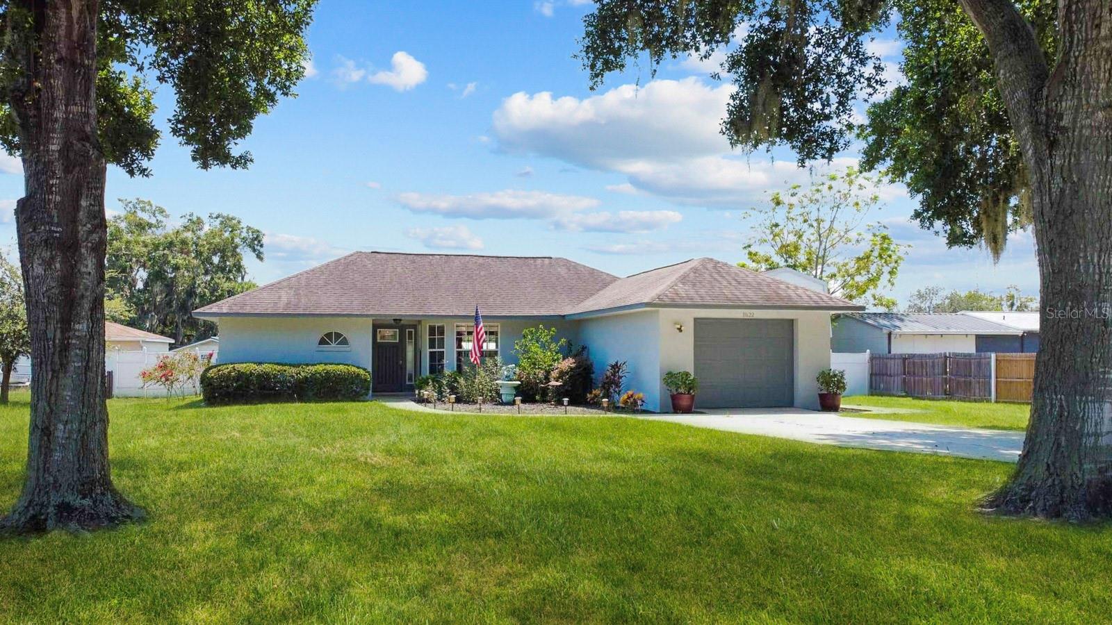Nowadays it is SO rare to find a move-in-ready home under 300k that has been immaculately kept, block construction, NEW ROOF, a 1/2 acre lot & NO HOA! Located in Leesburg, known as “The Lakefront City” this home sits off the shores of lake Eustis, part of the massive Harris Chain of Lakes. This home is positioned perfectly giving you both a large fenced backyard and a spacious front yard with a lengthy driveway where you can access the attached garage. A detached 2 level workshop sits to the right of the home with unlimited possibilities! The property has large trees and various native plants adding shade and pops of color! Inside you’re greeted with a cathedral ceiling, neutral wood look tile and an abundance of NEW windows giving this home great natural light & energy efficiency. A quaint kitchen has been updated with new cabinets and complementary granite countertops. Many of the fixtures and faucets have also been updated throughout the home. The new stainless appliances convey along with the handcrafted vintage cabinet in the kitchen! This home can be set up so many ways, currently the family room is being enjoyed as a sprawling dining room, but could definitely be used as a tv room with a cute sectional. A large enclosed sunroom spans a large portion of the of the home adding another area to relax and entertain. Currently the home is considered a 2 bed, 2 bath, but with a little framing a 3rd bedroom could be part of the existing floor plan. Also consider utilizing the block garage as another living space since you do have the detached garage/workshop too! A cute home to retire or start a family! Plenty of space to add on or enjoy it just as it is. Nice to have options! Lots of elbow room and freedom to make this your own! Lake County, particularly Leesburg has a history as an agricultural center for both watermelons and citrus. It also still embodies hometown traditions with monthly live acoustic music in the Town Square and the evening market on 5th Street, soccer and baseball fields bustling with activities on Saturday mornings and a never ending list of places to visit. You’ll look forward to the annual Holiday festivities and Leesburg Bike fest! Leesburg also offers a walkable downtown, sports leagues and recreational activities for the whole family! Many top doctors also call Lake county home giving you piece of mind for your wellness and healthcare. Education is also a top priority meaning you have options to fit you and your child's needs! A few more exciting perks is the proximity to Historic Mount Dora and Tavares Sea Plane haven! See map for details!