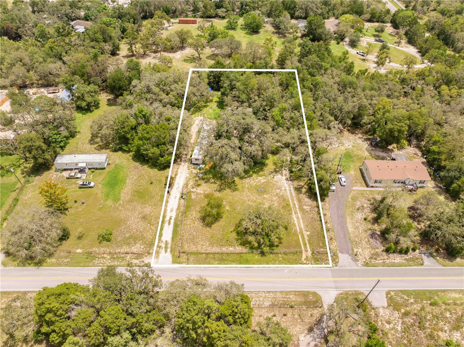 CASH ONLY!! The value here is in the land. This 1-acre in Spring Hill comes with two mobile homes that need serious work.
Keep one as a rental while you dream up plans or clear them both out and finally build that dream home you’ve been picturing. With plenty of room to spread out and a location close to shopping, Publix, and the Suncoast Parkway, this lot has all the potential—just waiting for the right buyer with vision (and cash). Buy land… they’re not making more of it.