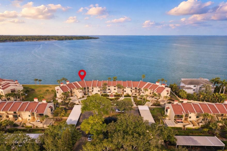 One or more photo(s) has been virtually staged. If you’ve been searching for your own slice of waterfront paradise, this MOVE-IN ready condo is a must-see! Ideally situated on the first floor, it offers convenient walk-up access for effortless everyday living. Located in SeaPointe Terrace—a boutique, three-story waterfront community at the southern tip of St. Petersburg—this home welcomes you with breathtaking panoramic views of Tampa Bay the moment you step inside. Designed for both comfort and entertaining, the spacious 1,405-square-foot open layout lives large and features beautiful, consistent tile flooring throughout. Expansive sliding glass doors from both the main living area and the primary suite lead to an impressive 44-foot private waterfront patio, perfect for enjoying morning coffee and evening sunsets, while an additional front patio provides a charming space for gardening or relaxing outdoors. The brand-new chef’s kitchen showcases white shaker cabinetry, stainless steel appliances, granite countertops, and a warm stone backsplash. The primary suite is a true retreat with million dollar morning water views, walk-in closet, and an en-suite bathroom with a custom double vanity and a beautifully designed shower. The guest bedroom features a built-in white shaker Murphy bed that will convey to the new owners for added versatility when you don’t have guests in town! The ideal split floor plan makes it perfect for having friends over, while still maintaining privacy. The right side of the SPACIOUS living room could easily be walled off to create a THIRD BEDROOM with its own en-suite bathroom if desired! It currently serves as a dream home waterfront office and workout area. If converted you still have an additional half bathroom right next to the kitchen too! Extensive upgrades include new luxury tile flooring throughout, fully renovated bathrooms, updated lighting fixtures, a new AC system, and a new water heater, while the HOA completed a new roof and seawall in 2023, enhancing the property’s low-maintenance appeal. Living in SeaPointe Terrace, you will enjoy resort-style amenities including a heated waterfront pool, kayak storage and launch, soon to be completed fishing pier, and tennis/pickleball courts, with HOA fees covering insurance, exterior maintenance, water, sewer, trash, cable, and Wi-Fi! Tucked away in a quiet enclave yet just minutes from vibrant downtown St. Petersburg and some of the nation’s top-rated beaches, this home offers the perfect balance of tranquility and accessibility. Don’t miss out on boutique waterfront living at its finest for an unbeatable price, schedule your private showing today!