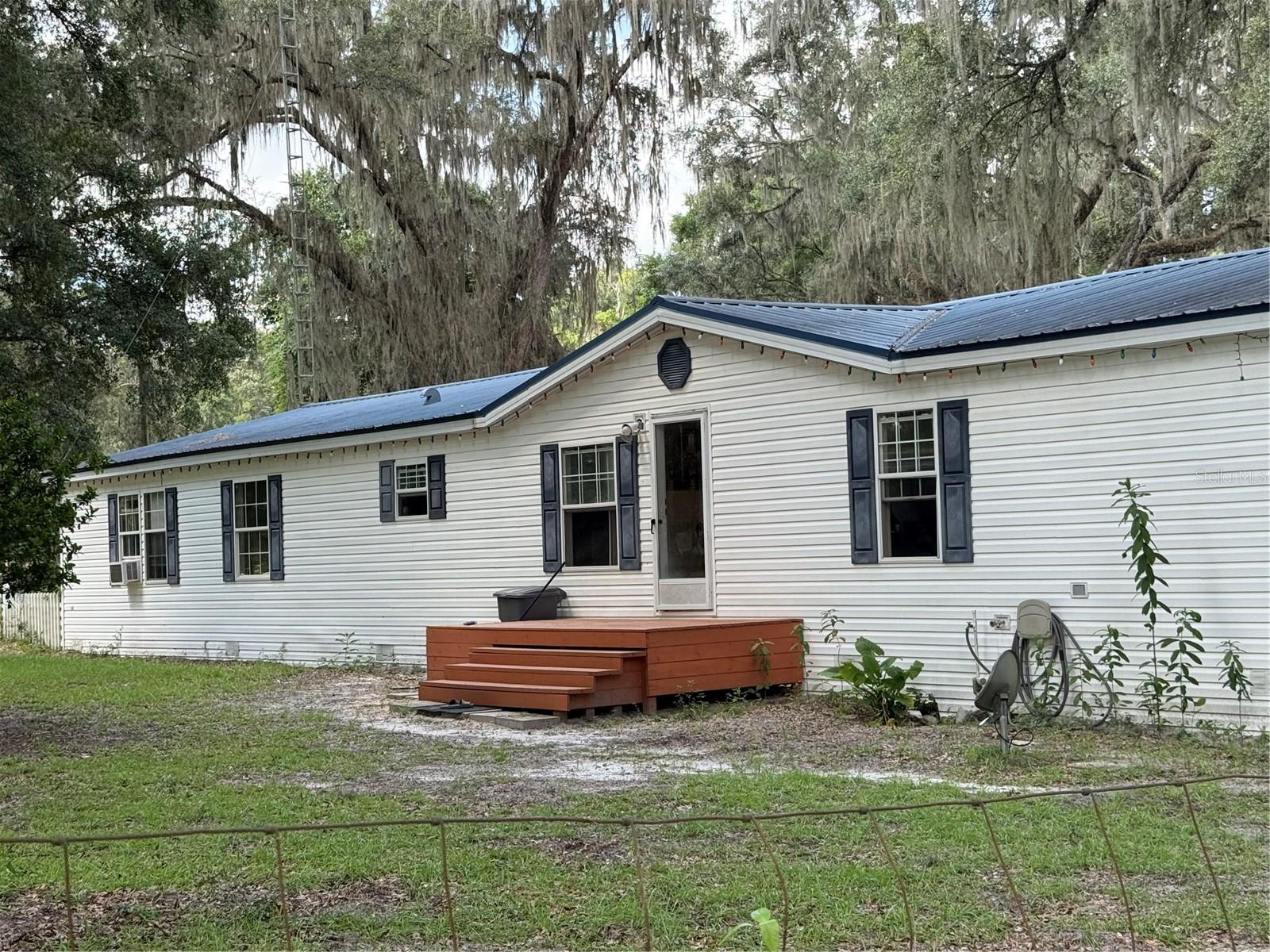 AMAZING HORSE FARM! Welcome to this serene mini farm in Meadowbrook Ranches in Beautiful Anthony Florida. This beautiful farm is situated on a fully fenced 4.31 acres. This property has two mobile homes on it, both with separate utilities. Other mobile is 1988 single-wide that is rented for 800.00 a month. Great rental income or for a family member. Main home is 2480 sq. ft. split/open 4/2 floor plan, cathedral ceilings, double pane windows, fireplace, separate laundry room. Formal dining, center island and wall to wall cabinetry. Second mobile is a 2/1, living, kitchen, and 14'x 12' rear family room. The property is cross fenced with two paddocks, four corrals around a 6 stall 12'x12' center hall barn, all with rolling doors. Exterior wash stall along with another 2 stall barn, all with metal roofs. There are 7 water sources around the farm, hooked up to a well with newer tank, meter and valves. If this isn't enough, the property has a 6" block tool shed/storage building, RV hookup and many beautiful fruit trees. Oranges, grapefruits, nectarines, plums, papaya, and if your a wine person, there are grape vines as well. You wont want to miss out on how this amazing mini farm will feel like home. . Bring your farm animals and make this home your own. Home is in need of some TLC.