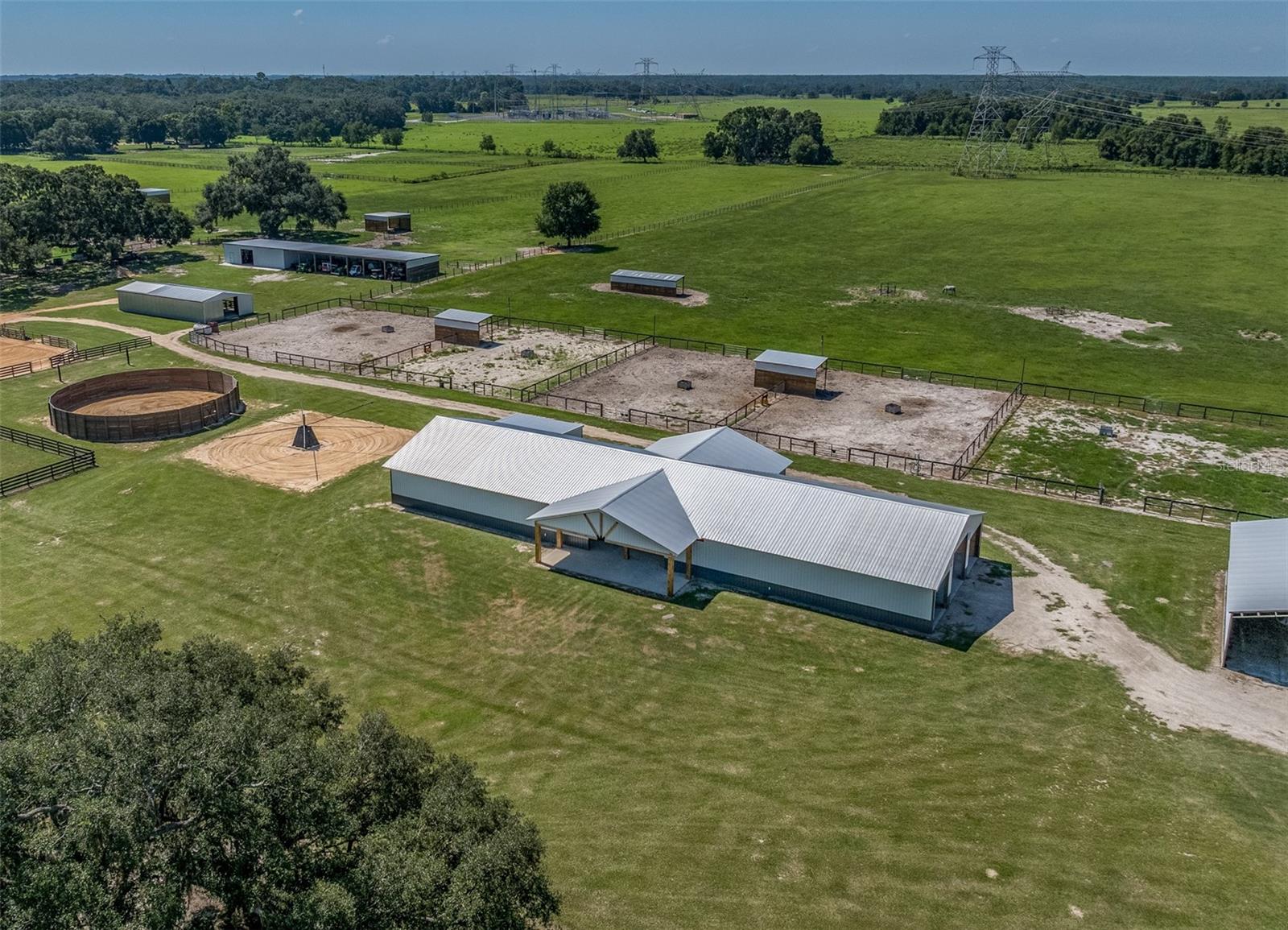 NO FLOOD ZONE! 30 Minutes to the WORLD EQUESTRIAN CENTER, 15 minutes to the FLORIDA HORSE PARK, 15 minutes to the VILLAGES. The advertised parcel has 16.7 acres, NEW (2024) 14 stall barn 144x44x12 with laundry room AND Office, 1/2 bath, feed/tack, wash rack this totals ALMOST 8,000 Sq. Ft of space! Plenty of room to add more stalls! Seller will add arena to this property with full price offer! ONE NEW residential home built (2024), hot walker, 60 foot round pen with 8 foot solid walls, NEW 4 board, no climb, electric fencing 7 paddocks, 1 pasture, TWO NEW hay barns on concrete slabs (30x51x12) , NEW (2024) shavings barn on concrete slab (18x31x14) and a NEW (2023) storage barn on concrete slab (24x24x10). Security System throughout property. All the time energy and money has been spent to complete this massive project. Move your farm right in! Take advantage of this fabulous deal and make this your dream farm today! High speed fiber optic cable is available. Property can be subdivided again to build your dream home! ***ADDITIONAL Adjacent Properties Available*** ADDITIONAL properties include 3 more parcels, 53 acres, 3 homes, 14 stalls, and additional outbuildings. That would total 69 acres MOL, 28 stalls and 4 residential homes. Ask for details about the whole package deal!