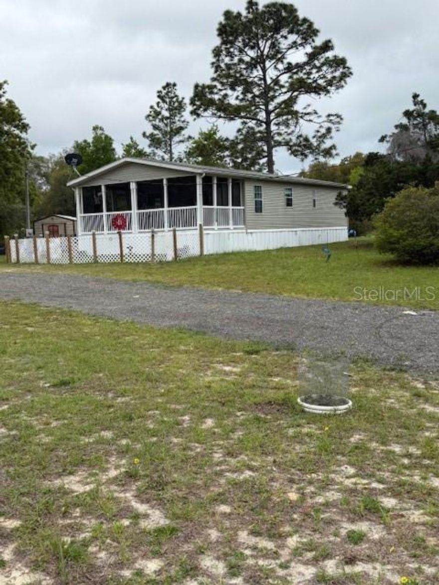Welcome to the country setting of Williston Highlands in Morriston, Fl. where you will find this 2011 2/2 double wide Jacobsen model sitting on 1.25 acres of land. The home has had new vinyl flooring installed, as well as new ceiling fans in main living area, window treatments, and water softener system. A new metal gate at the entry and dog run was added. Newly added to the property is a three bay pole barn with 30 amp plug for your camper storage and outlets in the work shop area.  There is also an additional 10X12 insulated shed for extra storage. A 50 amp plug is included on the home for easy generator hook up and usage. Many fruiting tress are found on this producing property such as apple, peach, lemon and lime. There is also a garden started with blueberries, blackberries, figs, and more. Move in and start the simple homesteading lifestyle you have been dreaming of. This property is close in proximity to many wildlife areas, gorgeous Florida springs such as the world famous  Rainbow springs, and even the Gulf for saltwater adventures such as the annual scallop season. This would make a wonderful forever home or a weekend getaway when you want to escape from the hustle and bustle of the big city life and get out in nature. Experience Florida at its finest at a great price point today. Negotiable to the purchase is a new golf cart, cub cadet riding mower, and washer dryer.