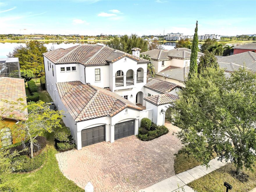 COMPLETE REMODEL ~ MOVE-IN READY ~ DIRECT LAKEFRONT W/PRIVATE BOAT DOCK AND LIFT, CUSTOM POOL HOME!  Lakefront Luxury meets Modern Mediterranean = a refreshing win-win!  Nestled in the heart of Dr. Phillips, along the shoreline of Sand Lake lies the "best kept secret" of Orlando for lakefront living in the Venezia Community.  No detail lost in this complete custom renovation. From the clean elegance of marble flooring to the upscale lighting fixtures, ambient lighting, and current/trending gray-scale décor throughout, you will sure to be impressed.  This home boasts a very flexible and accommodating floor plan, featuring the Primary Suite, PLUS another full en-suite bedroom for multi-generational living (in-laws or guests), PLUS an additional bedroom and full bathroom, all on the MAIN FLOOR of the home.  The second floor brings loads of flex space and is centered around the expansive bonus room which could be utilized as  a second family room, home theatre, exercise room, or play room.  There is ALSO a spacious dedicated "home office" or den/study/library featuring built-ins AND is flanked by dual second floor lanai/balconies from the office; one overlooking the gorgeous pool and lake, and the quaint street view featuring an outdoor built-in fireplace.  The kitchen is truly the heart of the home and is surrounded by the formal areas of the living room and formal dining room, PLUS it is open to the very spacious gathering room, complete with adjoining walls of sliding glass doors for captivating those gorgeous lake views and natural light.  A beautiful focal-point, floor to ceiling stone wall with fireplace and wall mount media connections encased on either side by built-ins.  The gorgeous wood ceilings and beams balances the neutral, fresh, and inviting color schemes with the rich, organic, wood detailing throughout the home.  This fully renovated kitchen boasts 42" cabinetry with an additional upper stack of upscale cabinetry, gorgeous counters, stainless appliances, gas-top cooking, island prep, and a large walk-in pantry.  The continuity of the fabulous kitchen remodel is mirrored throughout ALL of the bathrooms, plus ALL NEW FLOORING throughout, and all fresh paint inside and out.  Multiple outdoor lanai's, courtyards, balconies, fireplaces, and patios offer that well-loved and sought-after year round Florida outdoor living space and expands the functionality of the home. The tandem 3-CAR garage is accessible via a circular, pavered driveway.  Located in the Dr. Phillips A-rated school district,  restaurant row, upscale shopping and dining, and close to the airport and theme parks, this optimum location offers the ultimate in convenience for living and enjoying all that Orlando has to offer.  Enjoy views of the Orlando Eye, gorgeous city skyline and more from the privacy of your own estate, and start enjoying your new lakefront, luxury lifestyle that awaits in Orlando!