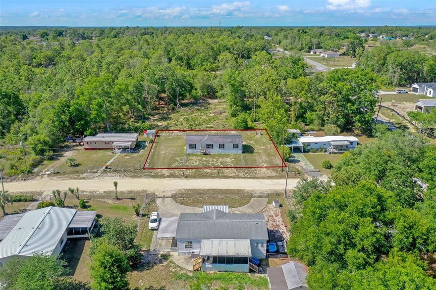 NEW MARKET PRICE, - DROPPED BY 10K -  Spacious Double-Wide with Bonus Room on Prepped Land – No HOA, RV Hookup, and Room to Grow!

Welcome to this move-in ready 2002 double-wide mobile home, recently placed on a cleared and prepped parcel complete with all major utilities updated and installed—including a NEW HVAC system, NEW septic with pump, NEW well, and NEW outdoor electrical connections. This home offers the perfect blend of space, function, and potential. VA financing available.

With three bedrooms, two full bathrooms, and a versatile bonus room featuring glass sliders, there is ample room for your lifestyle—whether you need a home office, playroom, second living area, for a future walkout to a screened lanai, patio or pool. The open floor plan, high ceilings, and ceiling fans throughout create a light, airy atmosphere perfect for comfortable living and entertaining.

The kitchen and dining area provide an abundance of space, with potential to expand counters or cabinets to suit your needs. A washer and dryer hookup is conveniently located right off the kitchen. Appliances include a refrigerator and range, come and see for yourself how this home has space and feels big compared to others with low traditional ceilings. The primary suite and bathroom has plenty of space with a soaking tub, separate shower and dual sink vanity.

Outdoors, enjoy your own private mailbox, enclosed chain-link fencing on the front, and plenty of parking for vehicles, recreational gear, work equipment or even your lake boat. There is also room for a RV hookup—a rare find with NO HOA or leasing restrictions, giving you the freedom to live, rent, or host as you wish.

Nestled in the heart of Central Florida, Belleview offers a balance of small-town comfort and convenient access to everything you need. No HOA, freedom of having pets and enjoying your land and making it your own.

Outdoor enthusiasts will appreciate Belleview’s access to some of Florida’s most beautiful natural areas. The nearby Lake Weir is perfect for boating, fishing, and lakeside dining. Just a short drive away, the Ocala National Forest offers hiking, birdwatching, and crystal-clear springs like Silver Springs State Park—famous for its glass-bottom boat tours. Golfers will also find multiple scenic golf courses nearby.

Belleview is located just south of Ocala and north of The Villages, ideal for those looking to stay close to shopping, dining, entertainment, and quality healthcare is about 15 minutes away and offers nightly live music, boutique shopping, and numerous dining options. For more extensive retail or medical services, Ocala is about a 20-minute drive and offers everything from malls and hospitals to cultural venues and historic downtown charm.

Traveling in and out is a breeze, with several airports within reach:
 • Ocala International Airport – approximately 30 minutes away, perfect for private and regional flights.
 • Orlando International Airport (MCO) – about 1 hour and 20 minutes, offering a full range of domestic and international flights.

Bring your vision and TLC to make this spacious property truly your own. Whether you are looking for full-time living, an income opportunity, or a seasonal retreat with flexibility—this home is ready to meet your needs.
