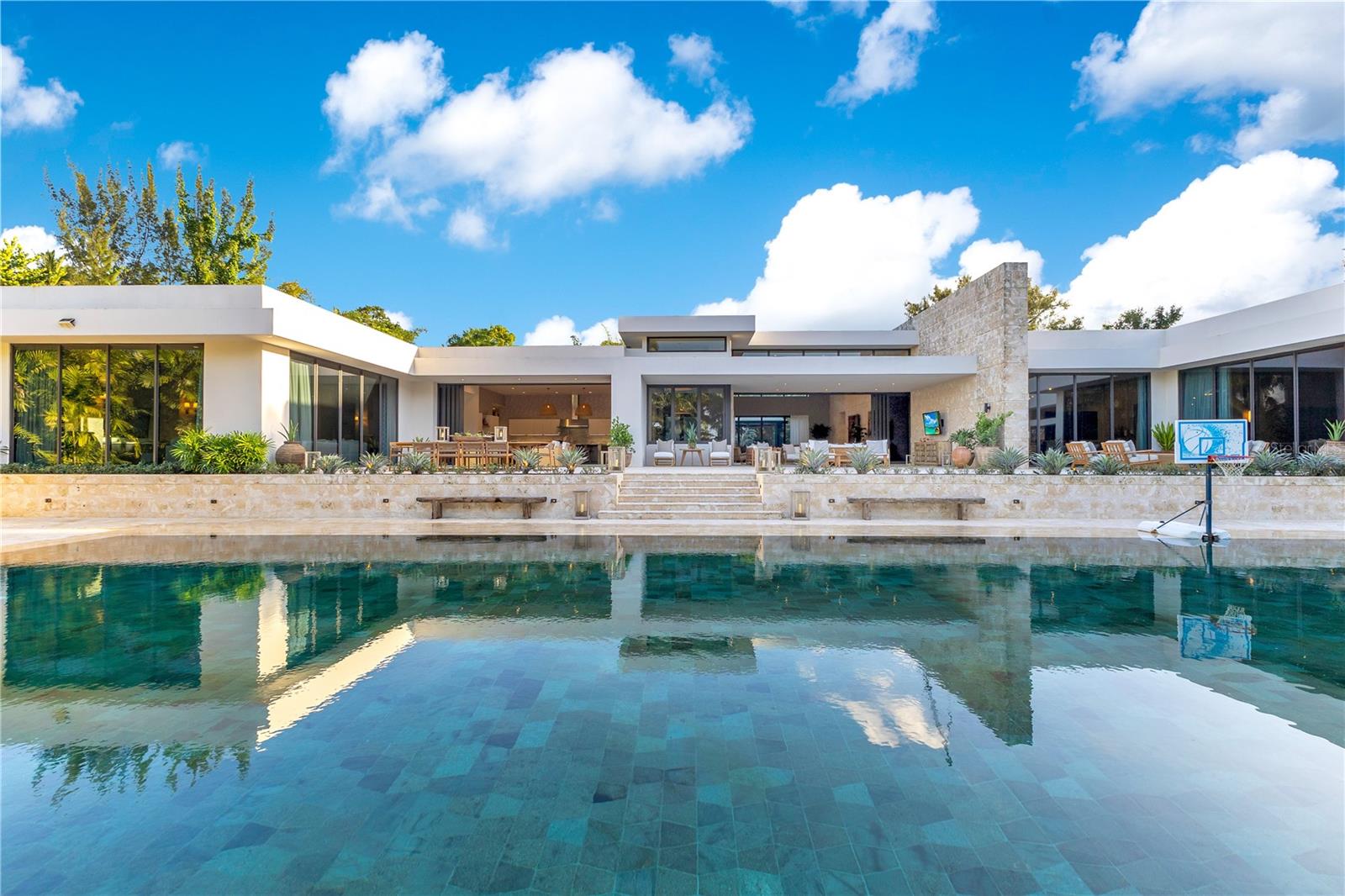 Dorado Beach Estates - A Masterpiece of Unparalleled Luxury in Dorado Beach Estates. A true architectural marvel, this is a one-of-a-kind residence that redefines luxury, modern elegance, and grand living. Nestled within the ultra-exclusive, gated community of Dorado Beach Estates one of the most sought-after communities within Dorado Beach, a Ritz-Carlton Reserve. This Estate provides an unrivaled lifestyle of sophistication and exclusivity. Spanning an impressive total area of 20,629 sq. ft., this estate is designed to perfection, seamlessly blending exquisite craftsmanship with cutting-edge innovation. The main residence features four lavish bedroom suites, each with a spa-inspired ensuite bathroom, alongside a versatile office/flex room. For guests or extended stays, a fully equipped private Casita with a separate entrance provides ultimate privacy. A 6,511 sq. ft. basement provides additional parking and storage. A state-of-the-art movie theater with an immersive sound system sets the stage for an unparalleled cinematic experience, while a dedicated wellness room is perfect for relaxation. From the moment you step inside, you are enveloped in an atmosphere of refined luxury. Towering floor-to-ceiling Coralina stone walls, hand-selected travertine flooring, and expansive 10' sliding glass doors create a sense of openness and seamless indoor-outdoor living. Every surface and material speaks to uncompromising quality, including Taj Mahal granite, Exotic Sahara Noir, and Velluto Onyx countertops, ensuring that no detail has been overlooked. The modern, open-concept main kitchen is as visually stunning as it is functional, featuring panoramic views of the pool, premium Sub Zero refrigeration and Wolf appliances, and an imported marble island. Poliform custom cabinetry adds a sleek, contemporary touch to this culinary masterpiece. For those who love to entertain, the separate chef’s kitchen is a true culinary haven, equipped with two Sub Zero refrigerators and freezers, two Sub Zero wine refrigerators, an electric cooktop, a polished Taj Mahal granite island, and expansive storage for effortless organization. Overlooking the pristine pool and golf course, the master suite is a haven of tranquility and indulgence. The master bedroom features a private ensuite with a relaxing steam room, perfect for unwinding after a long day, a two-person infinity spa tub, exquisitely clad in Calacatta Gold marble, as well as separate His & Hers showers, commode closets, and bespoke walk-in wardrobes. A commercial-grade gym, outfitted with state-of-the-art fitness equipment, is included in the sale, ensuring a luxurious wellness experience from the comfort of home. Designed for entertainment and relaxation, the expansive outdoor terrace seamlessly extends from the main living areas, revealing a magnificent saltwater swimming pool, clad in imported Indonesian Sukabumi stone, a statement of elegance and tranquility. This estate is not only a showpiece of luxury but also a beacon of sustainability. Cutting-edge eco-friendly amenities include a solar panel system, Tesla batteries, a commercial-grade Volvo generator, an advanced water filtration and reverse osmosis system, and two 2,500 gallon water cisterns. Seamless smart home automation places luxury at your fingertips controlled via smartphone or tablet. This estate is more than just a home it’s a lifestyle of prestige, exclusivity, and unmatched refinement. Seller accepts cryptocurrency as payment.