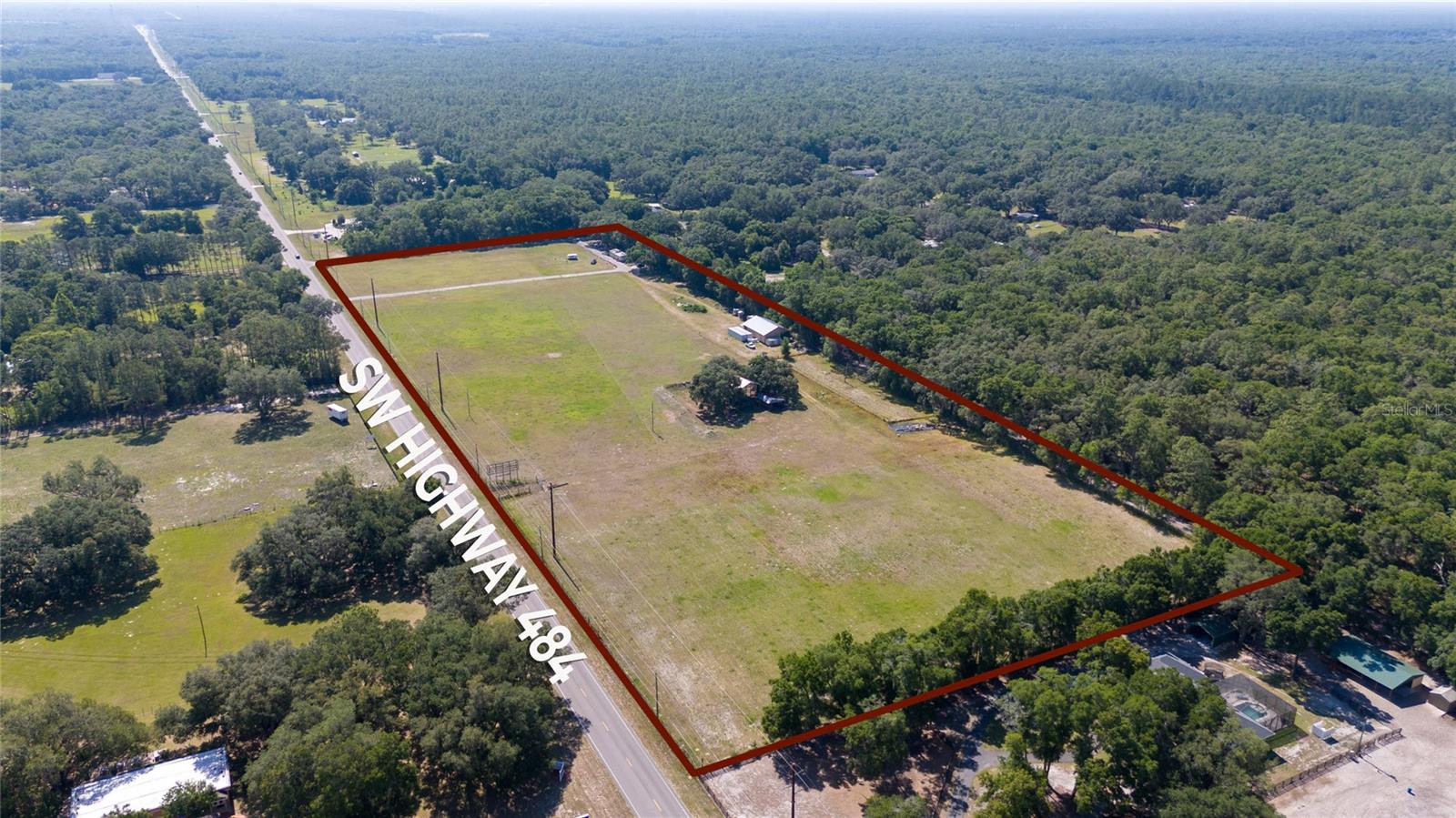 17+ acres with direct private Florida Greenway access!! This is your chance to own 4 parcels all in one!! Close to town and the Florida Horse Park, this beautiful property has unlimited possibilities! The 40x60 metal barn can easily be converted into stalls. Keep your trailers under 22ft high pole barn with concrete floor or create more stalls!! For the farm equipment there is another smaller pole barn. The property is completely perimeter fenced with multiple gates to access the property. The 3 bedroom 2 bath recently remodeled mobile home , for a hired hand or temporary living while you build your dream home!! Don't miss out, book your showing today!!